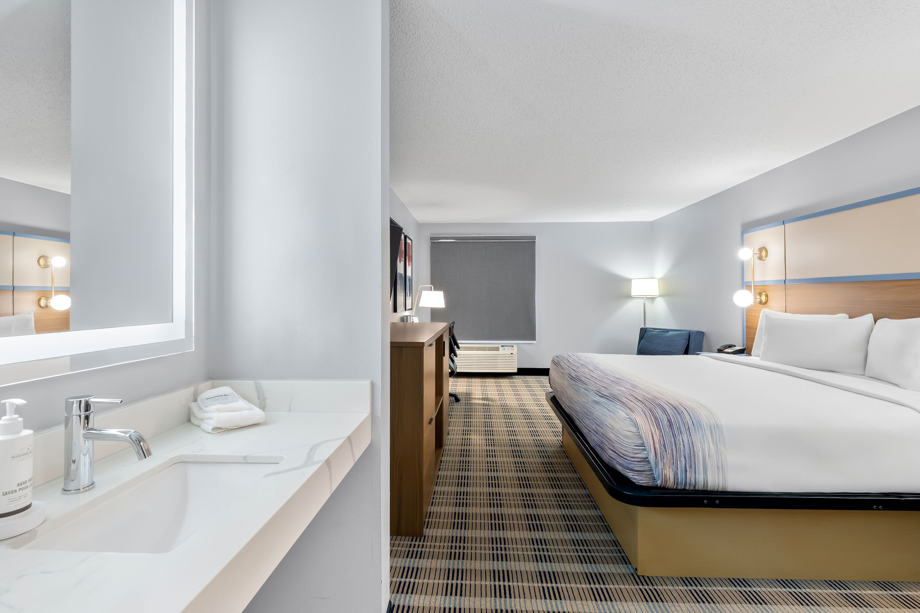 King bed guest room at the AmericInn by Wyndham Columbus Wisconsin in Columbus, Wisconsin