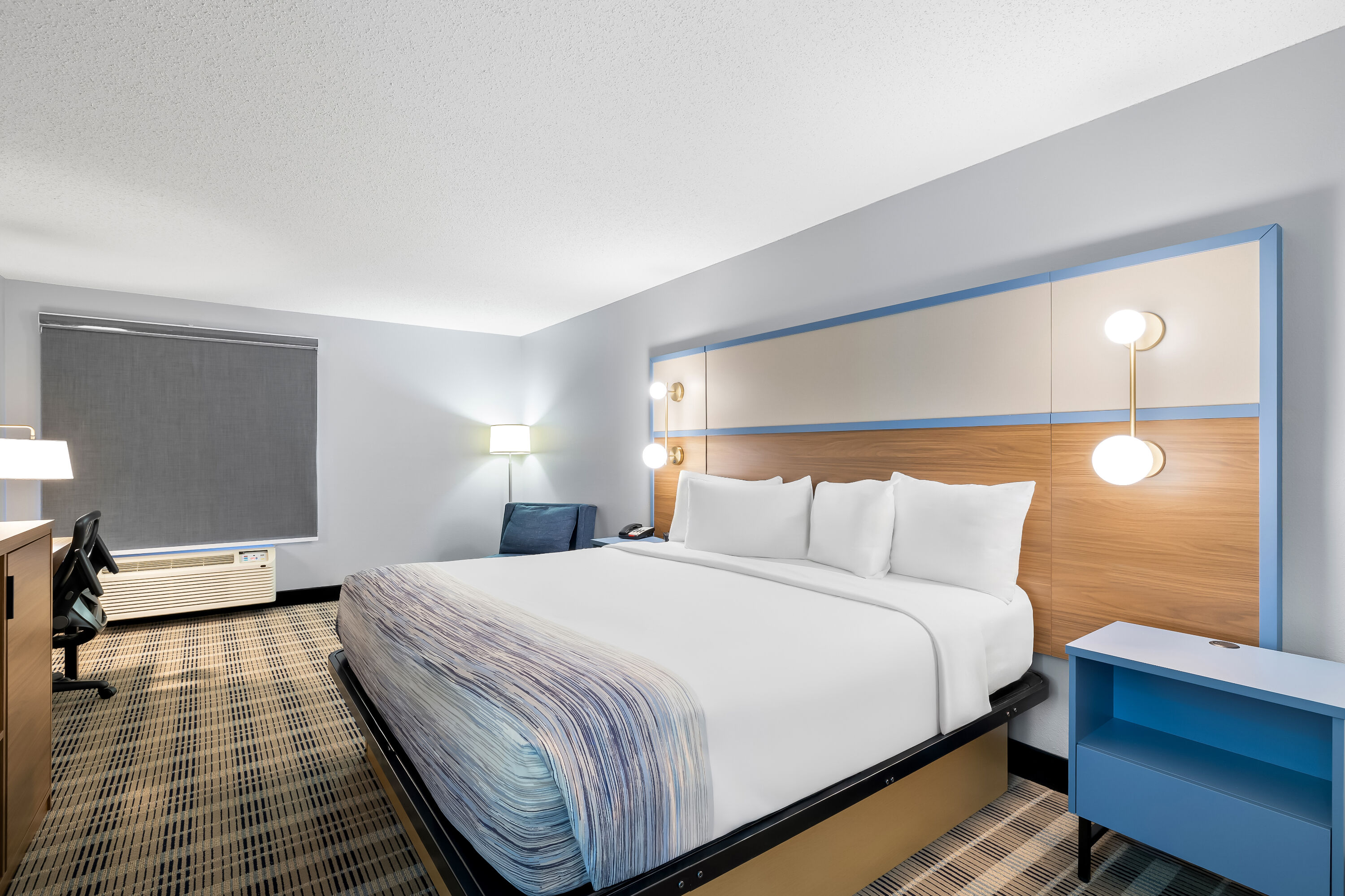 King bed guest room at the AmericInn by Wyndham Columbus Wisconsin in Columbus, Wisconsin