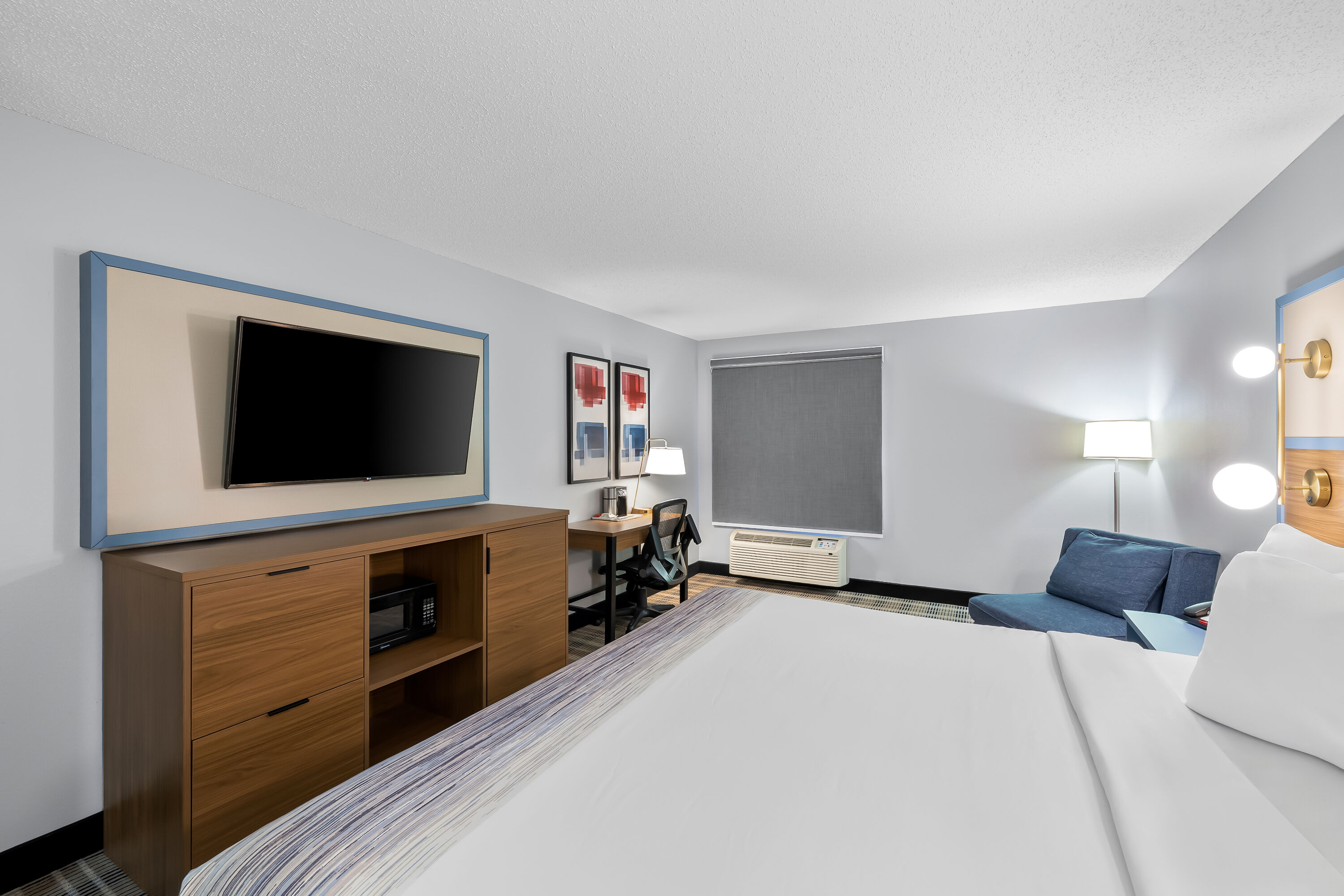 King bed guest room at the AmericInn by Wyndham Columbus Wisconsin in Columbus, Wisconsin