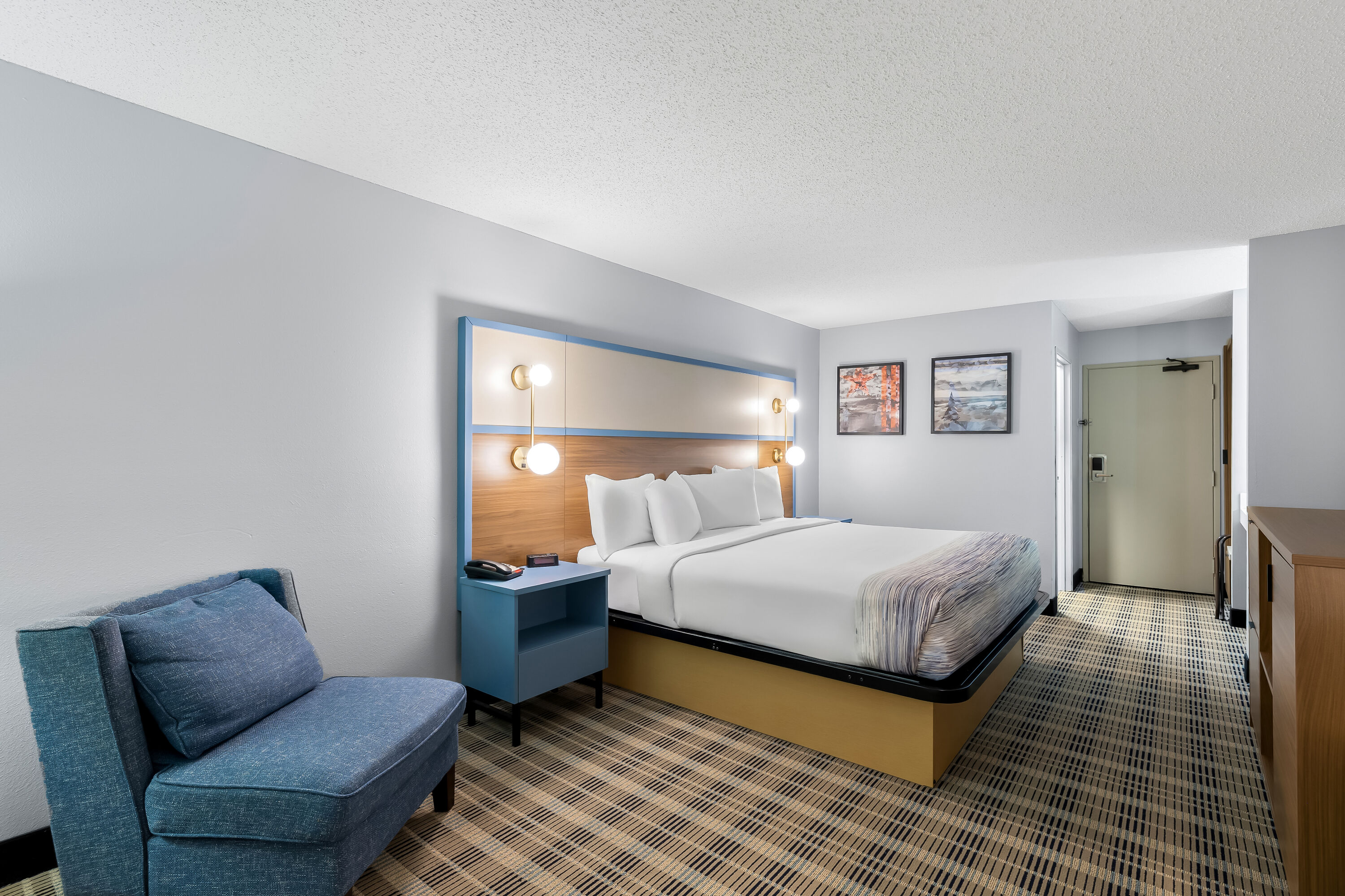 King bed guest room at the AmericInn by Wyndham Columbus Wisconsin in Columbus, Wisconsin