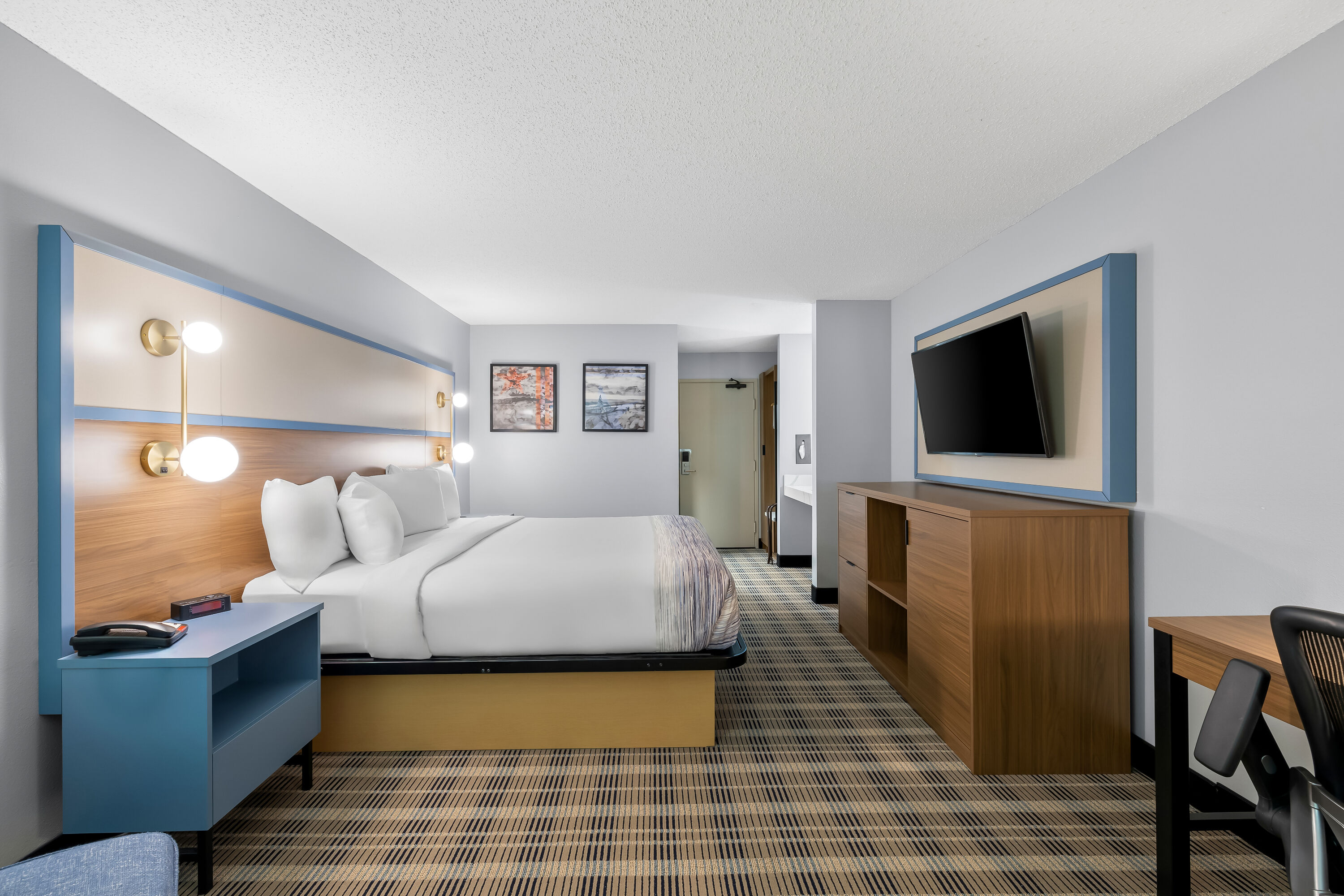 King bed guest room at the AmericInn by Wyndham Columbus Wisconsin in Columbus, Wisconsin