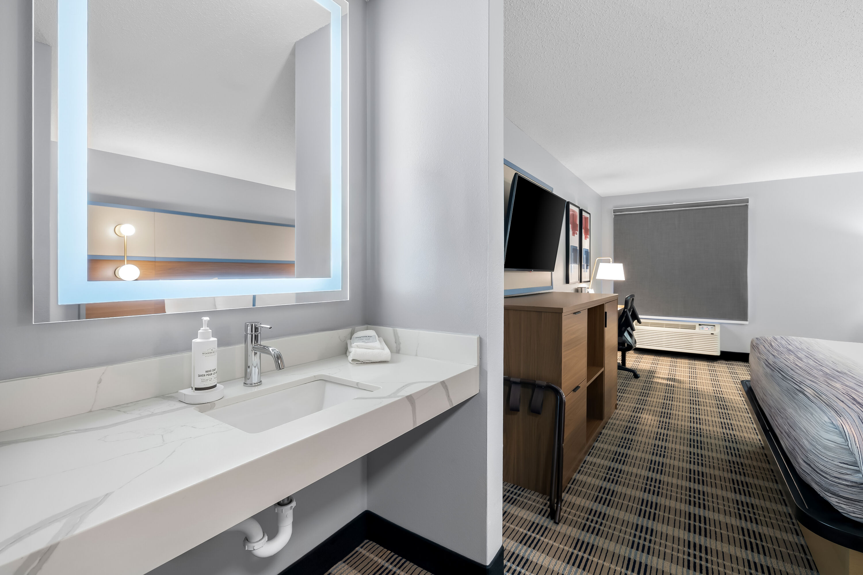 King bed guest room at the AmericInn by Wyndham Columbus Wisconsin in Columbus, Wisconsin