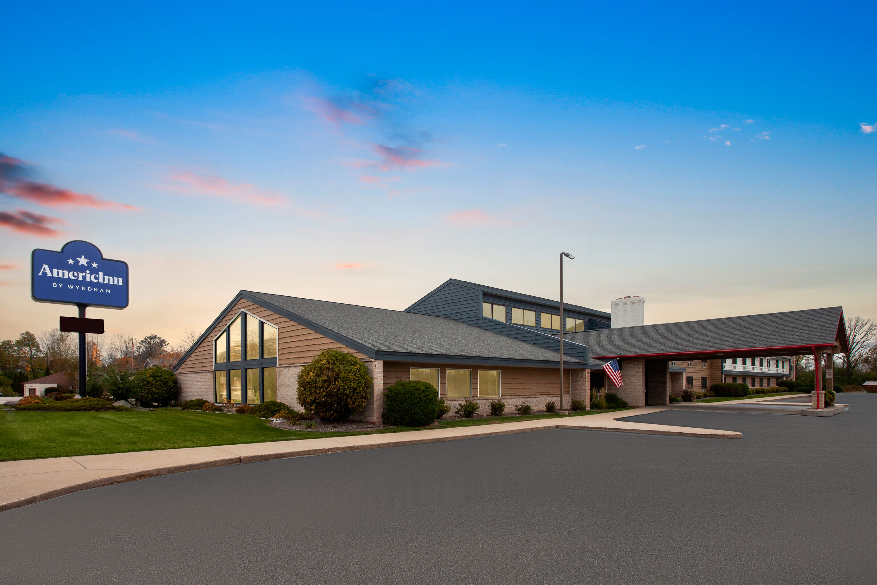 Exterior Dusk Image of AmericInn by Wyndham Green Bay West hotel in Green Bay, Wisconsin
