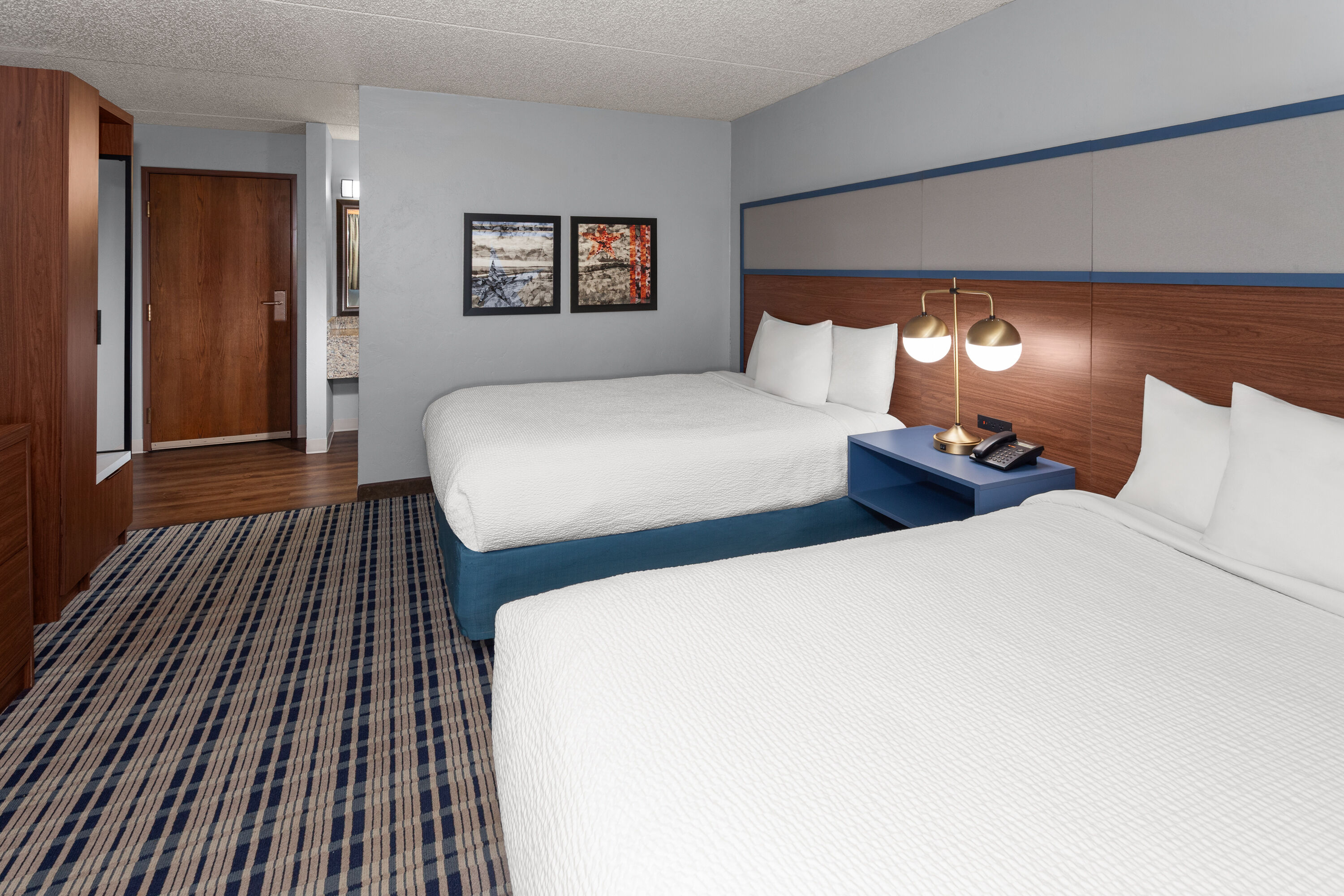 Guest room at the AmericInn by Wyndham Green Bay West in Green Bay, Wisconsin