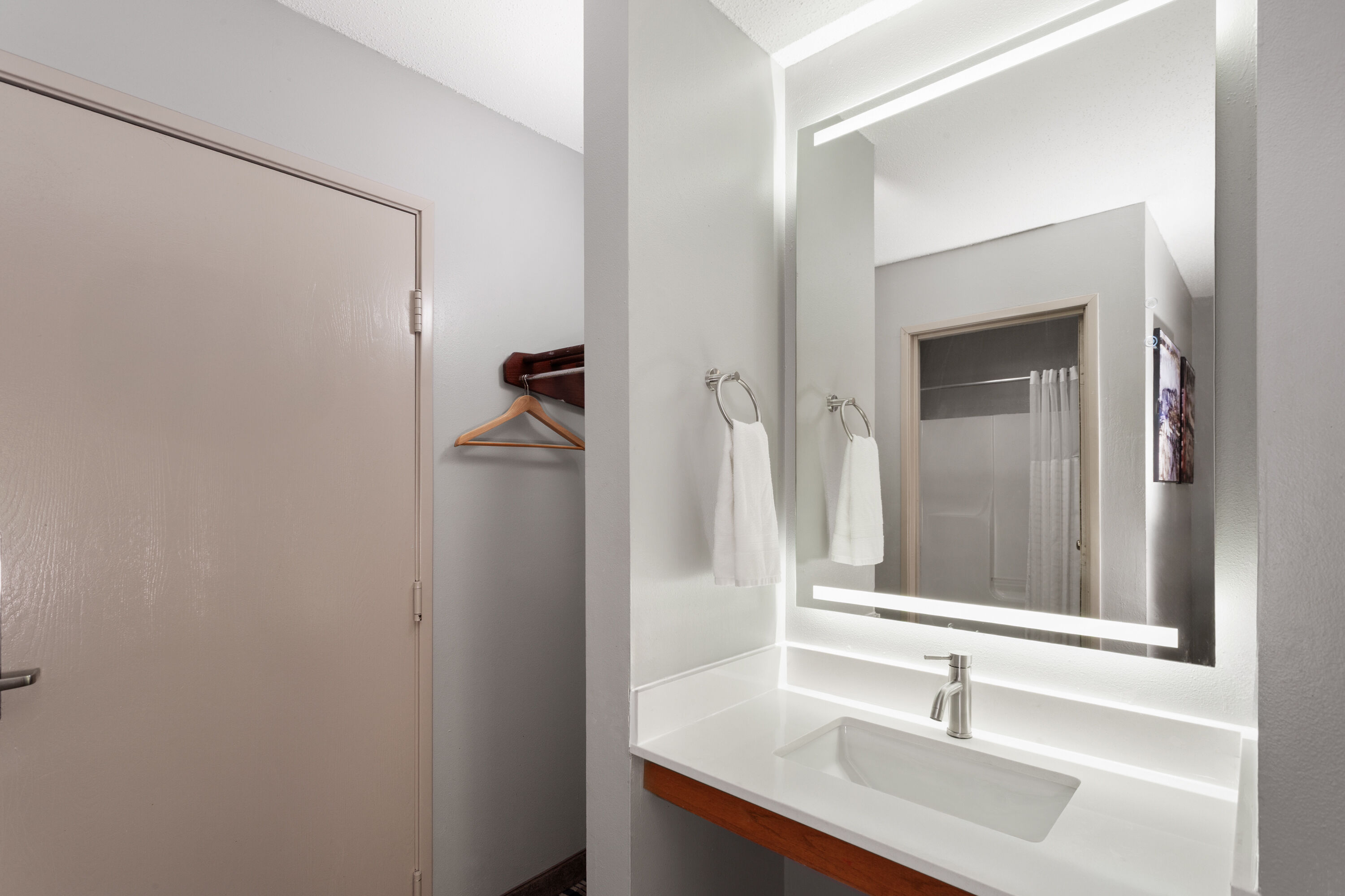 Guest room bath at the AmericInn by Wyndham Lake Mills in Lake Mills, Wisconsin