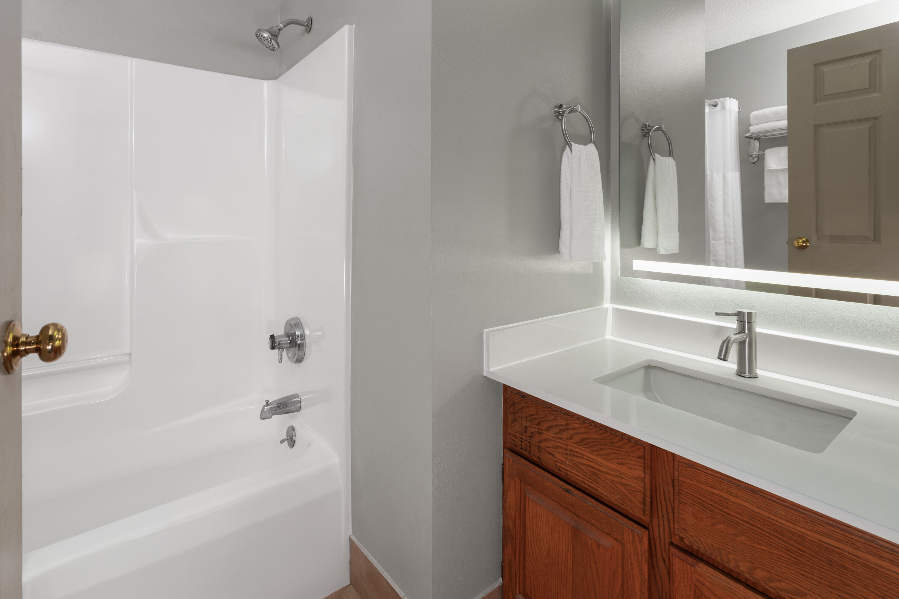 Guest room bath at the AmericInn by Wyndham Lake Mills in Lake Mills, Wisconsin