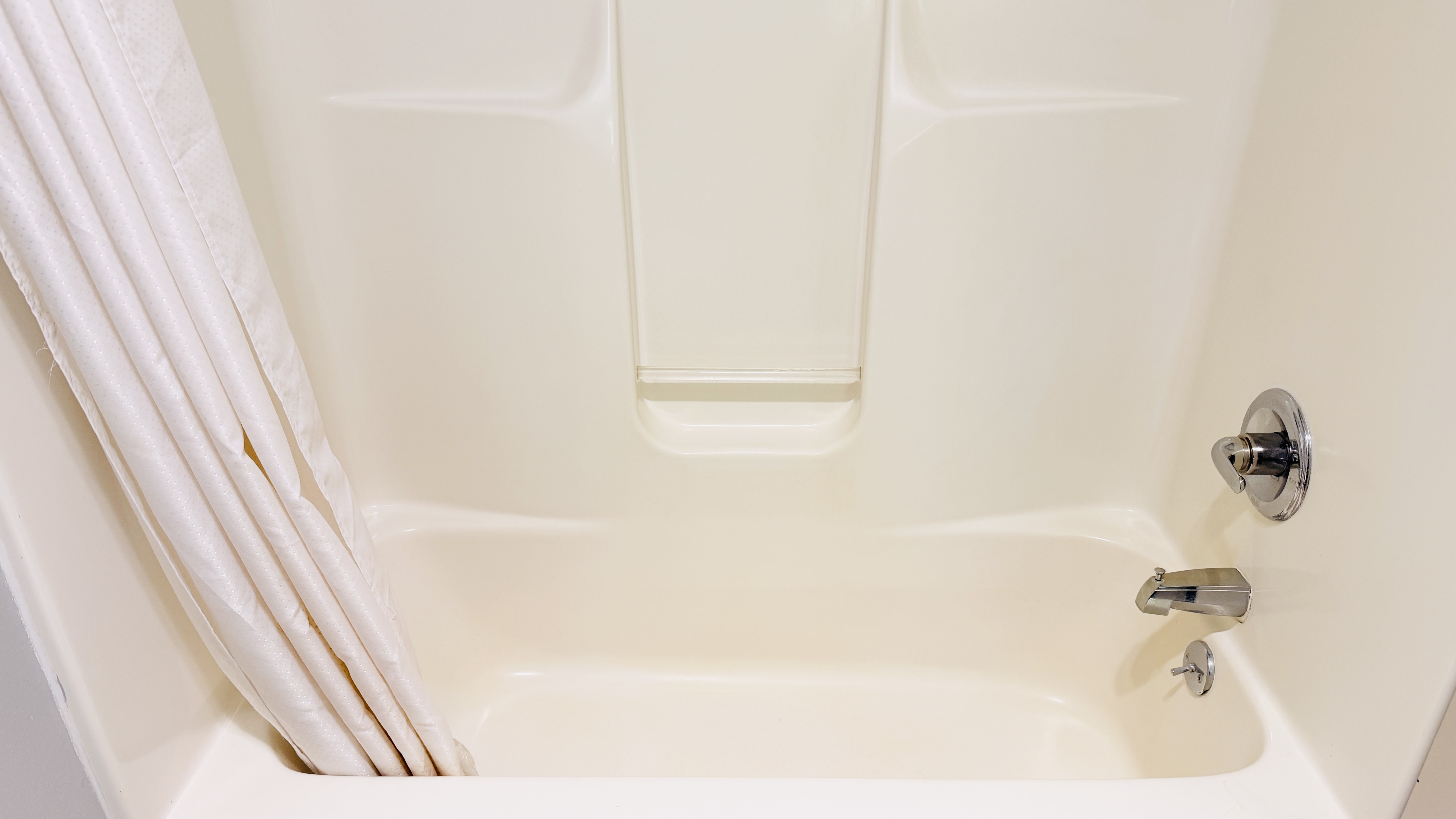 Guest room bath at the AmericInn by Wyndham Lake Mills in Lake Mills, Wisconsin