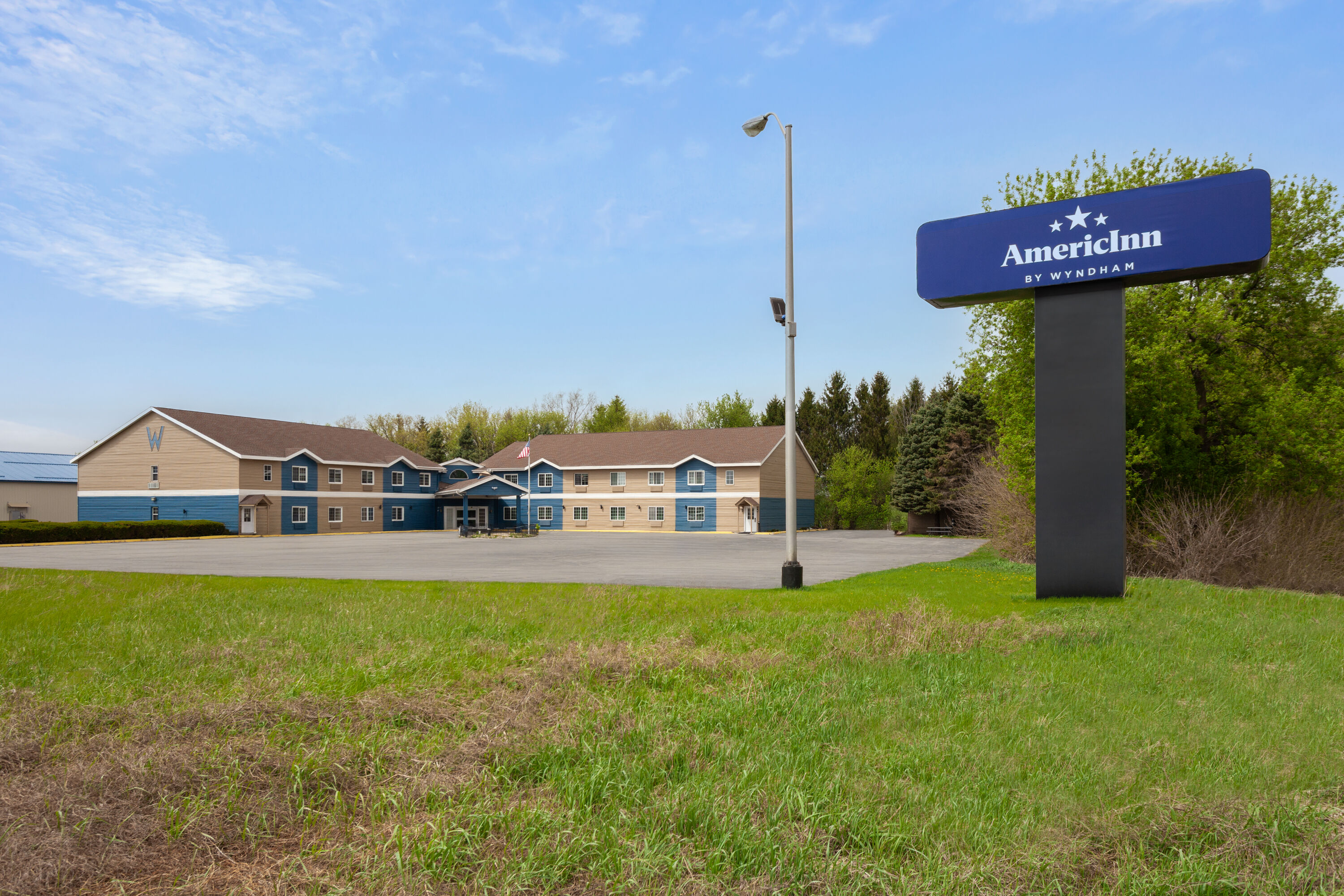 Exterior Day Image of AmericInn by Wyndham Lake Mills hotel in Lake Mills, Wisconsin