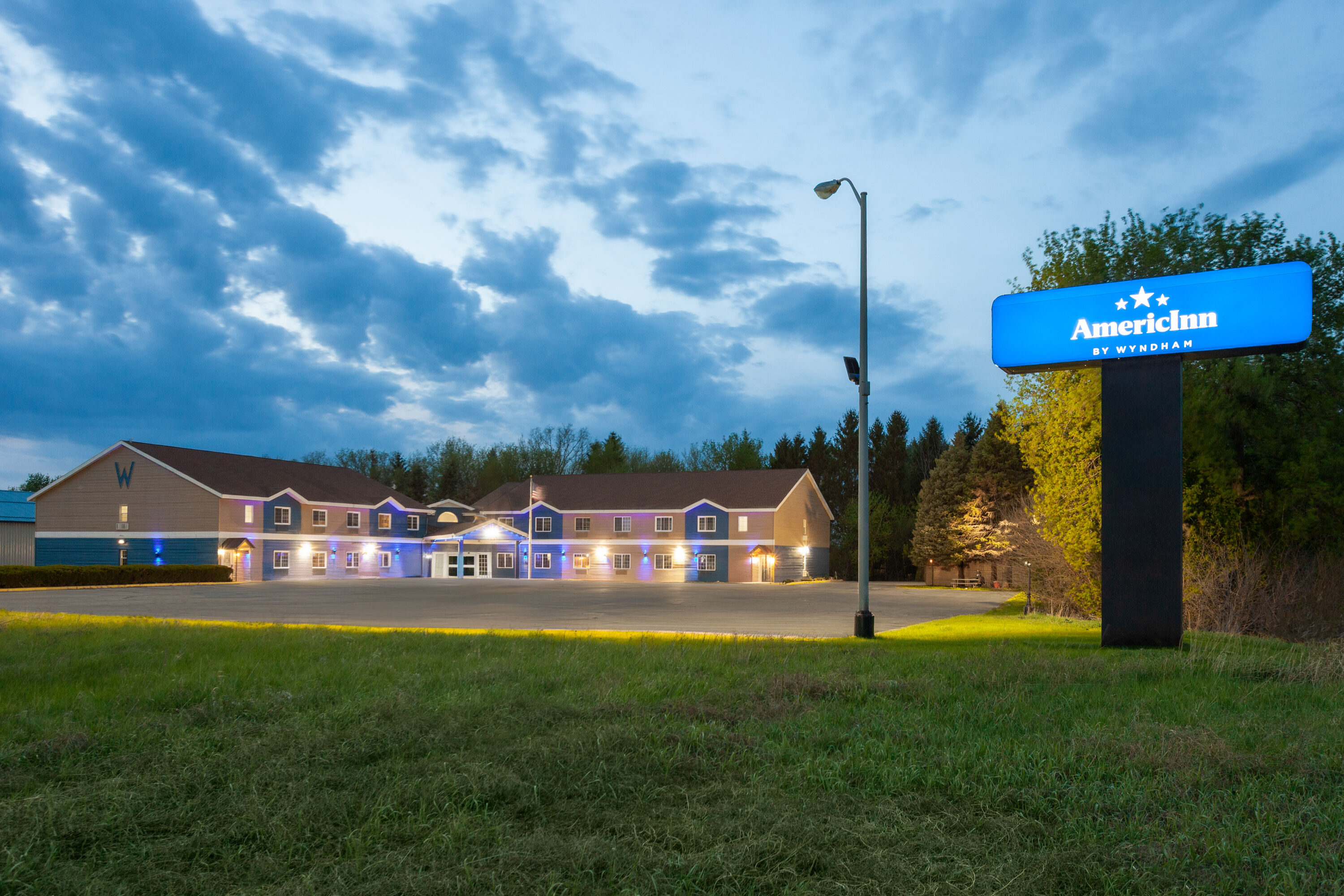 Exterior Dusk Image of AmericInn by Wyndham Lake Mills hotel in Lake Mills, Wisconsin