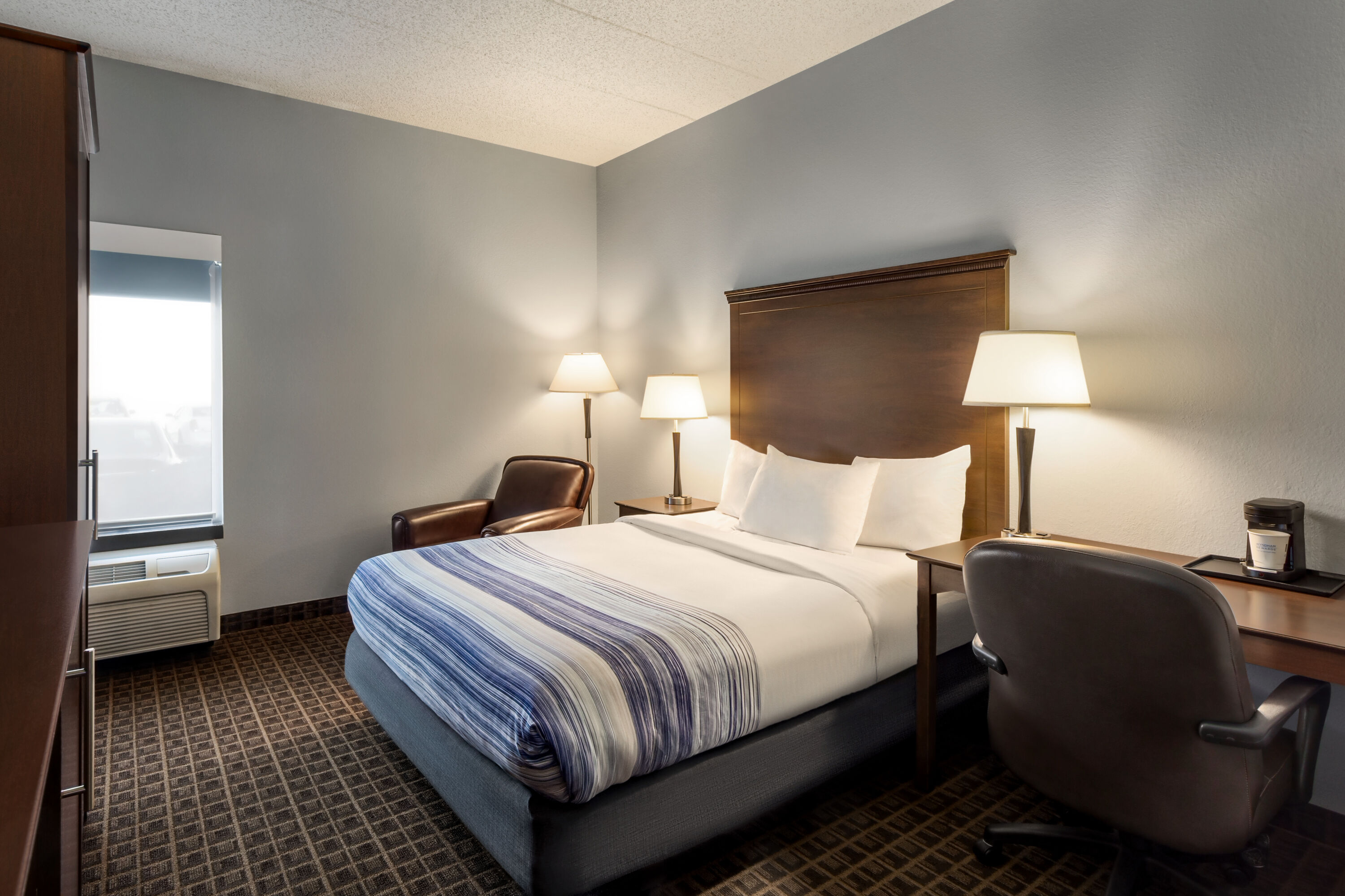 Guest room at the AmericInn by Wyndham Madison West in Madison, Wisconsin