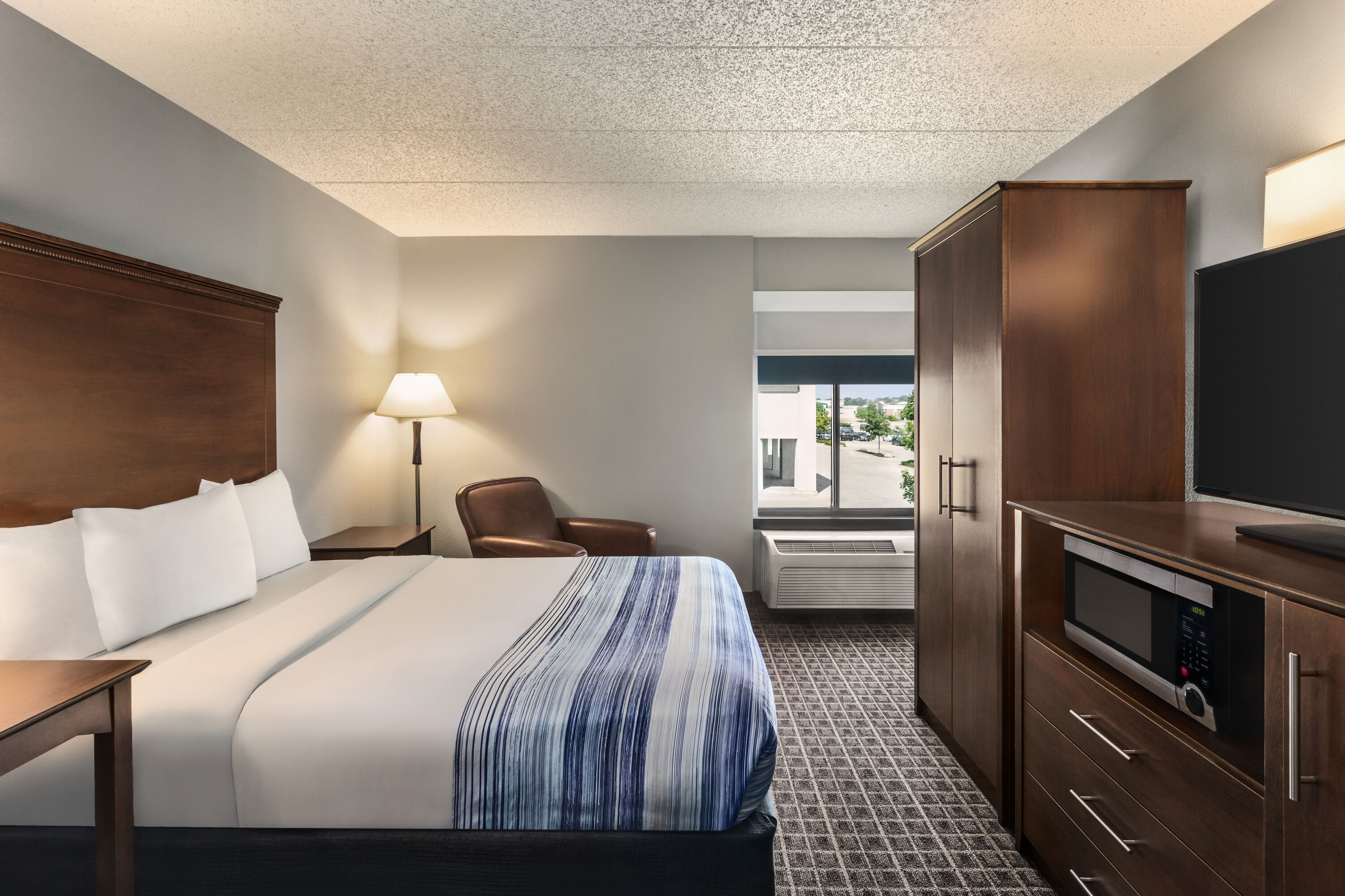 Guest room at the AmericInn by Wyndham Madison West in Madison, Wisconsin