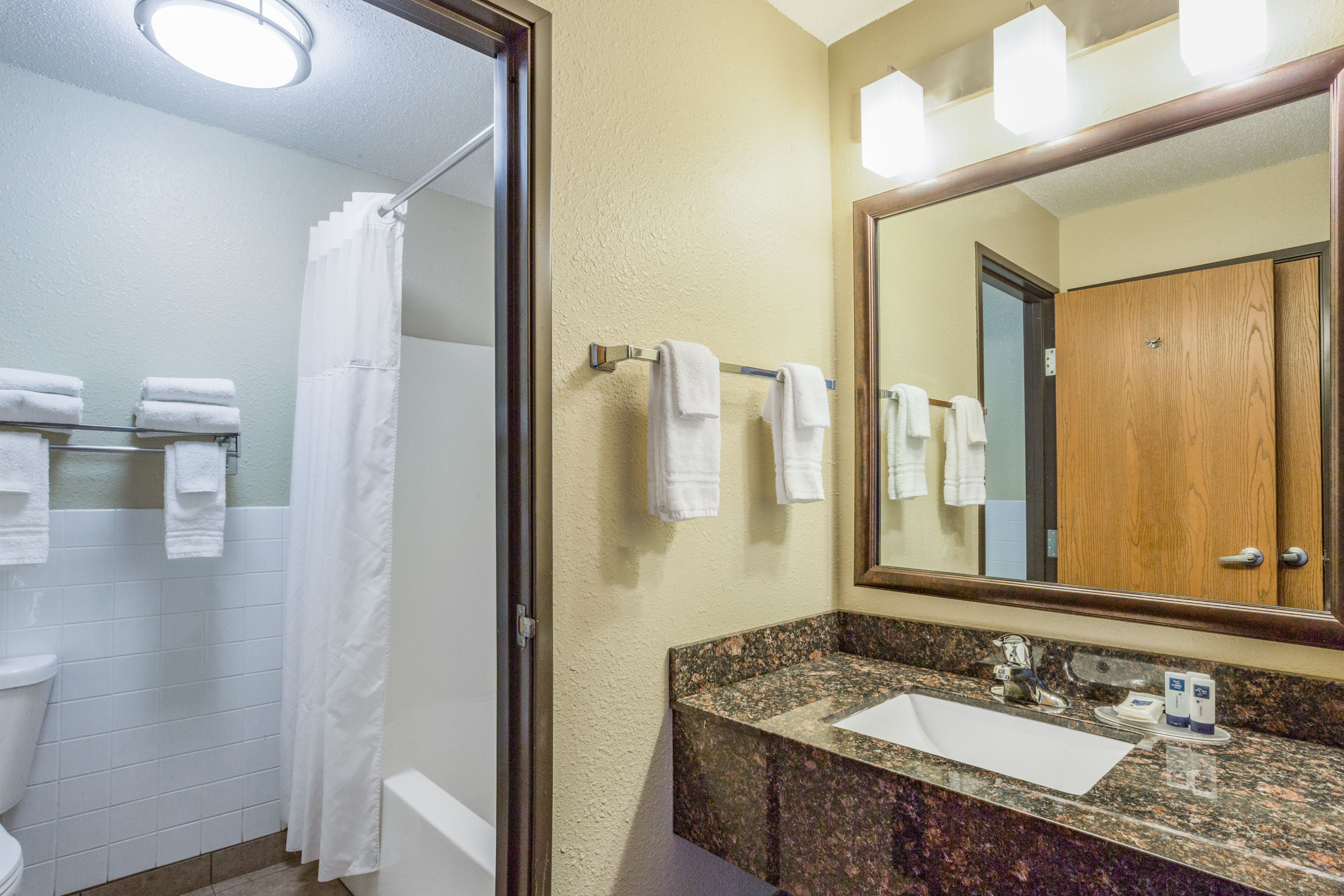 Guest room bath at the AmericInn by Wyndham Menomonie in Menomonie, Wisconsin