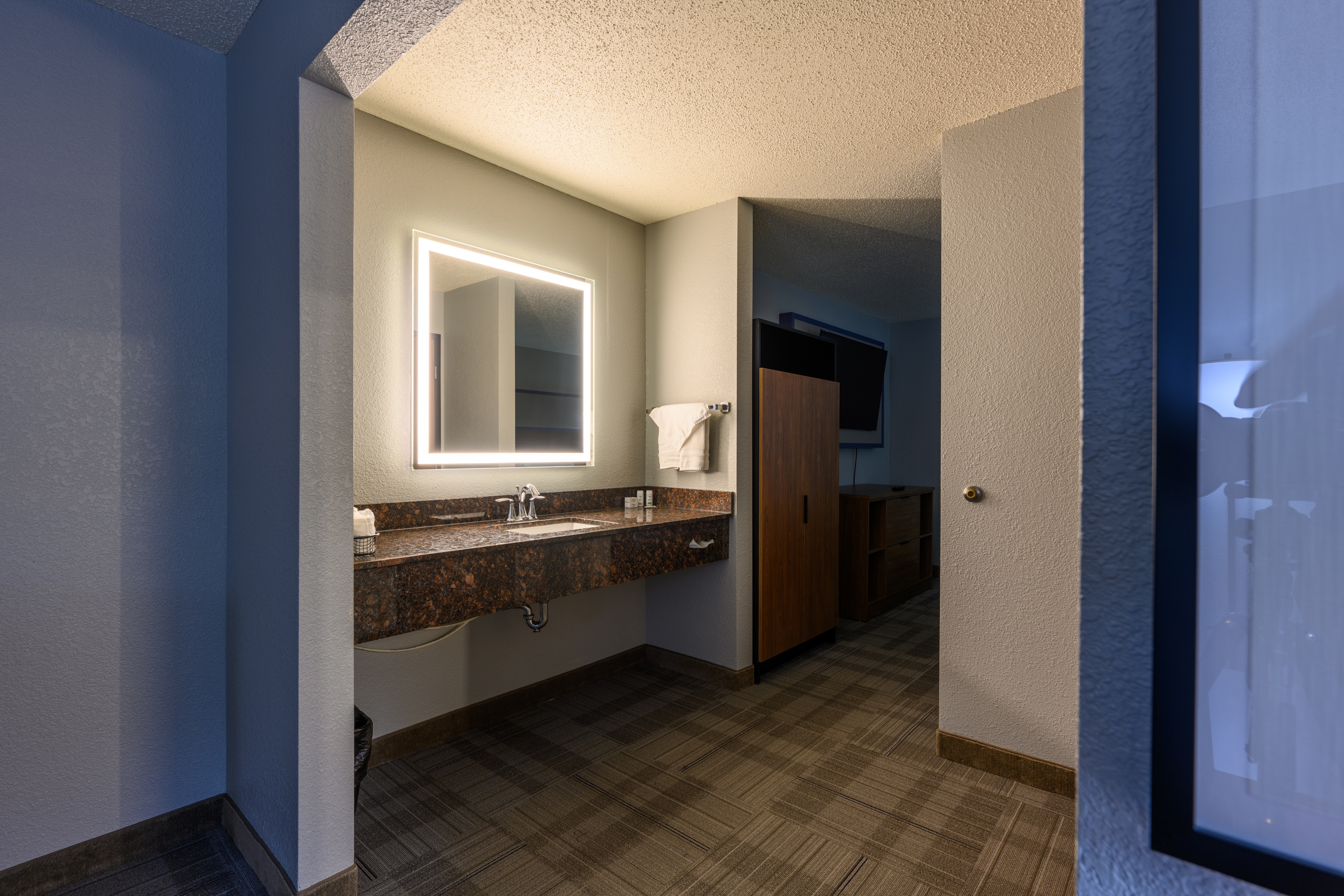 Guest room bath at the AmericInn by Wyndham Monroe in Monroe, Wisconsin
