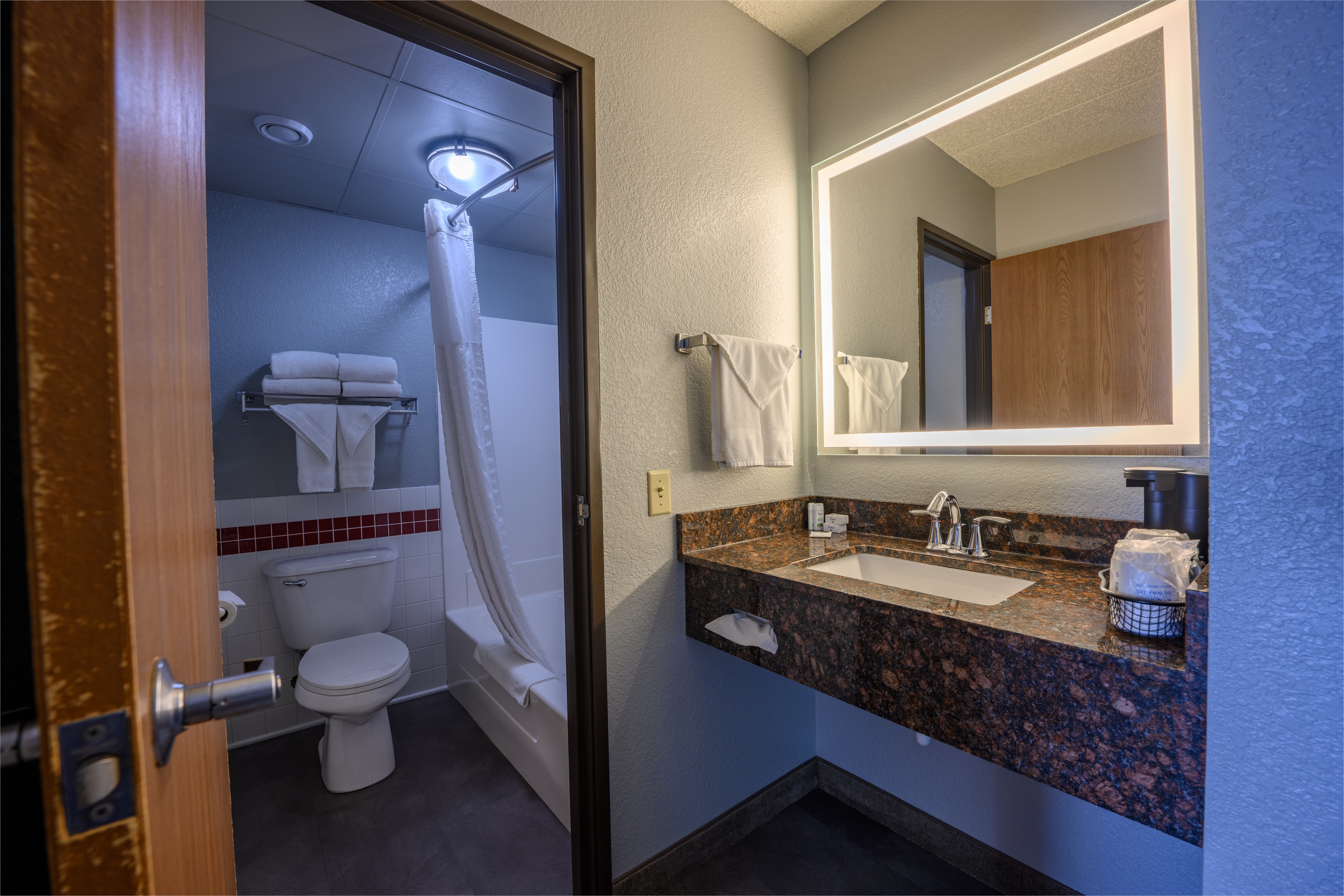 Guest room bath at the AmericInn by Wyndham Monroe in Monroe, Wisconsin