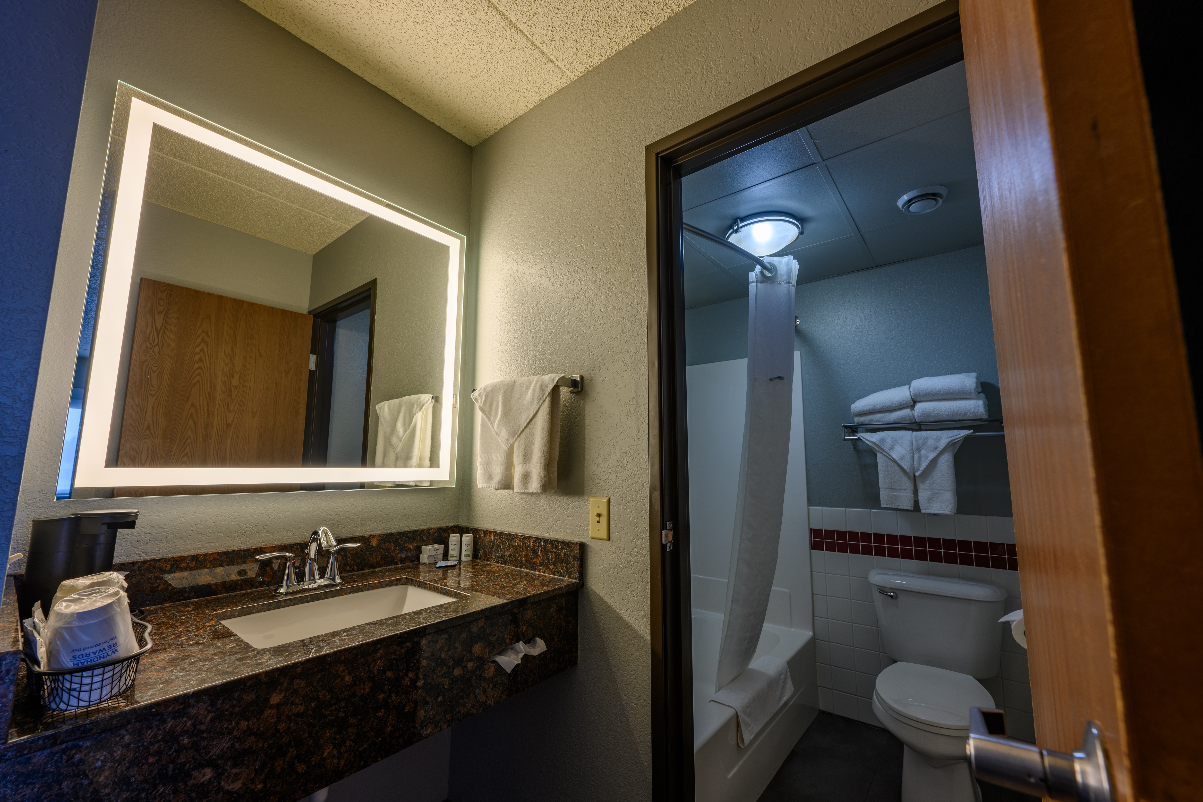 Guest room bath at the AmericInn by Wyndham Monroe in Monroe, Wisconsin