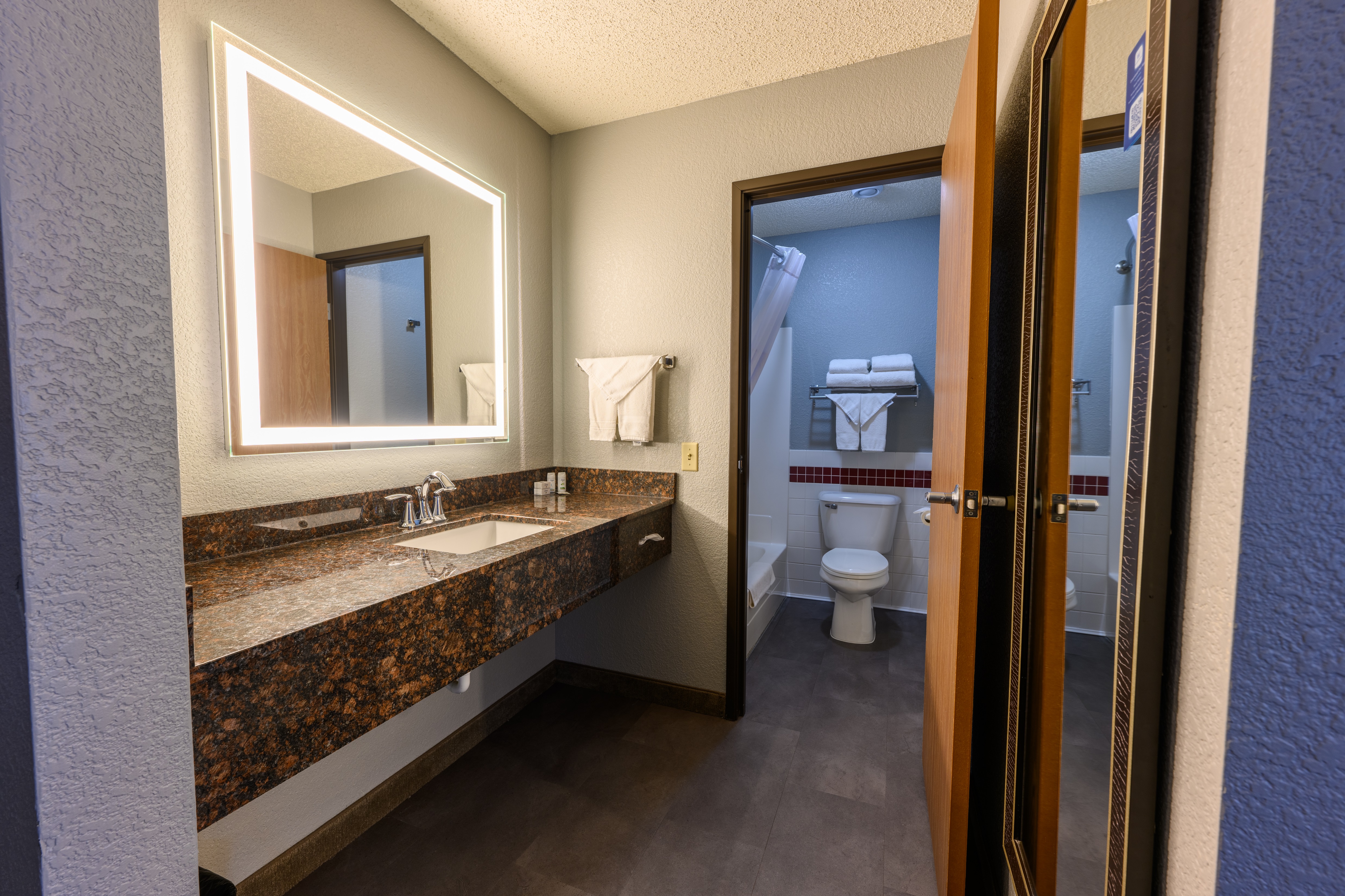 Guest room bath at the AmericInn by Wyndham Monroe in Monroe, Wisconsin