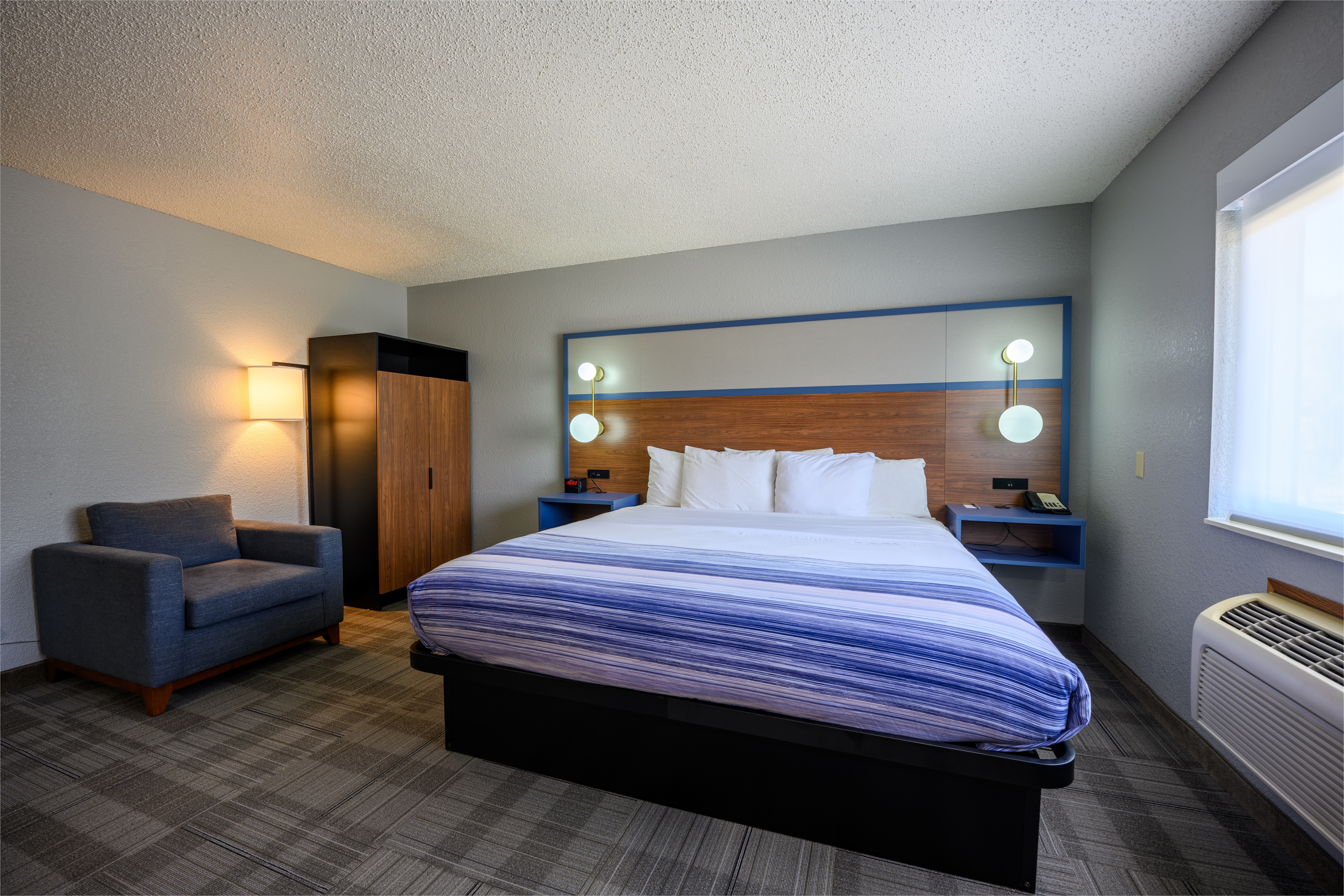 Guest room at the AmericInn by Wyndham Monroe in Monroe, Wisconsin