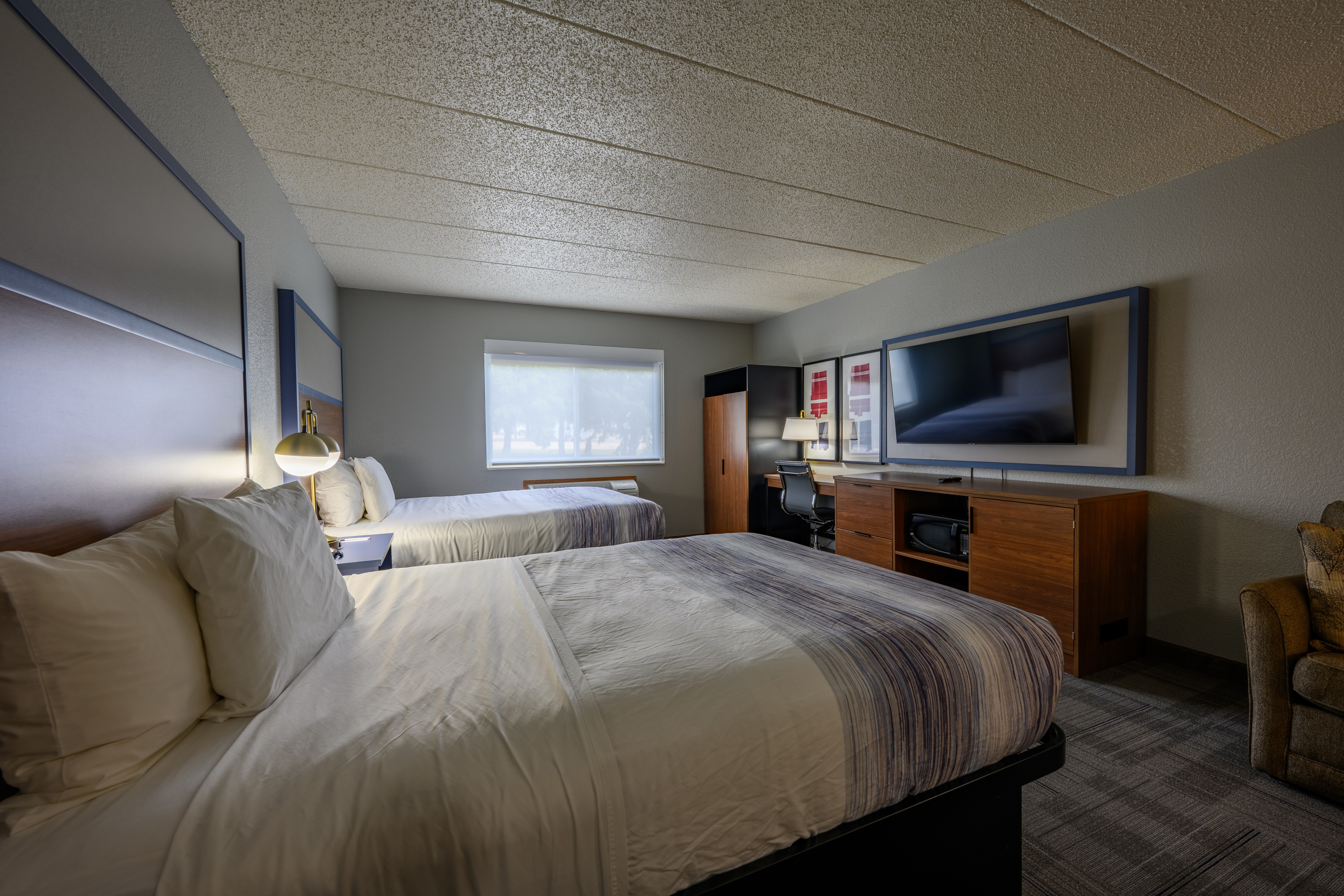 Guest room at the AmericInn by Wyndham Monroe in Monroe, Wisconsin