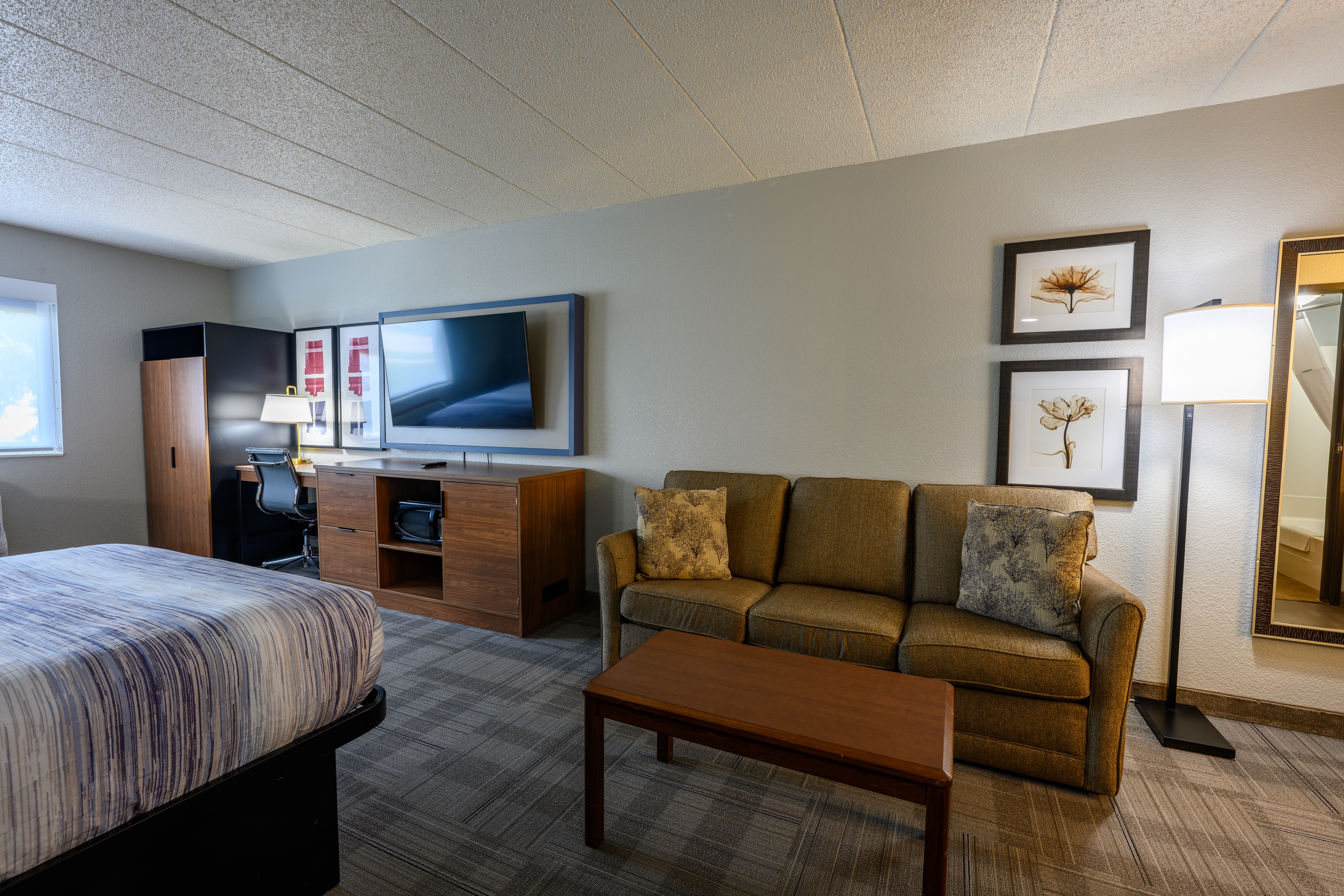Guest room at the AmericInn by Wyndham Monroe in Monroe, Wisconsin