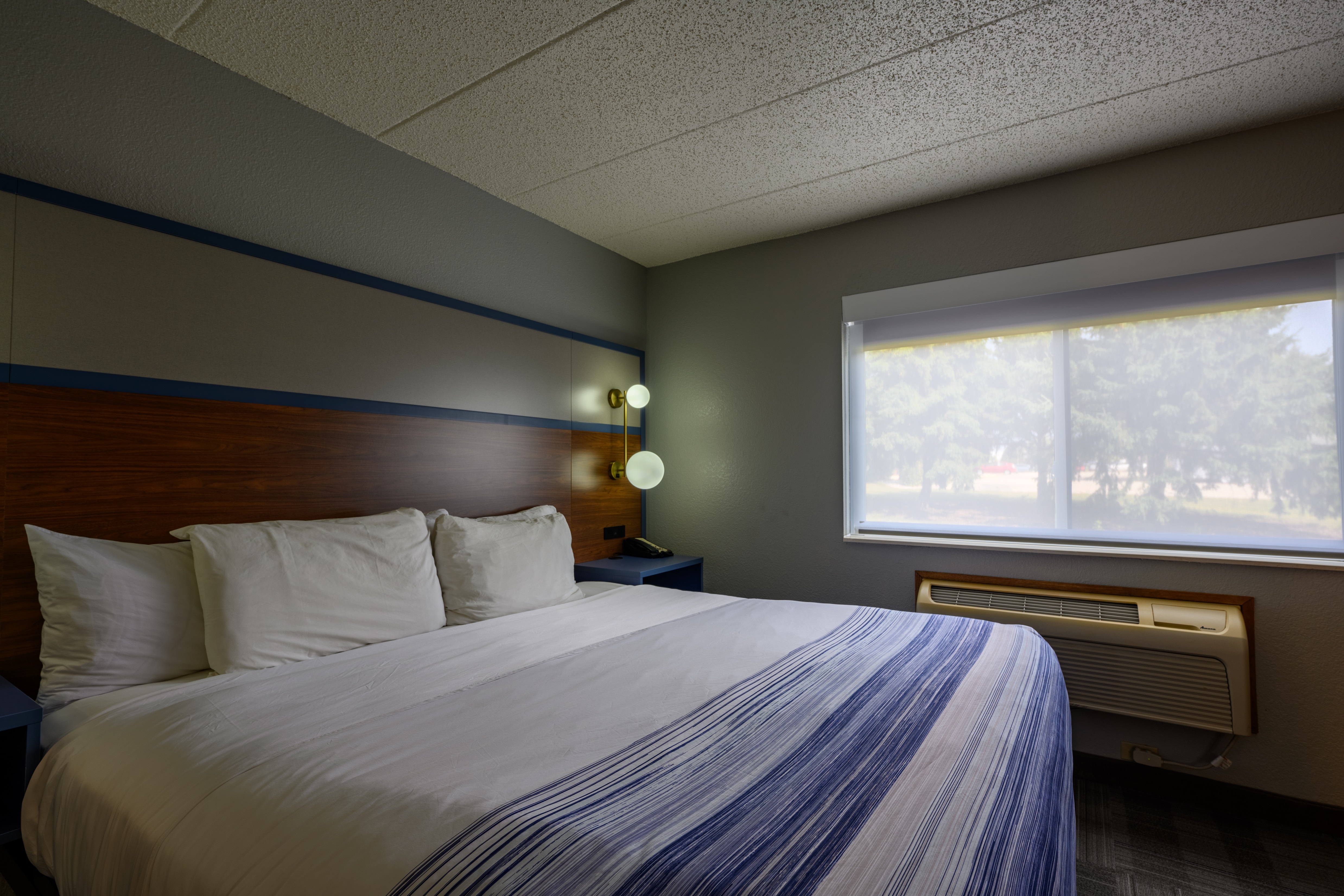 Guest room at the AmericInn by Wyndham Monroe in Monroe, Wisconsin