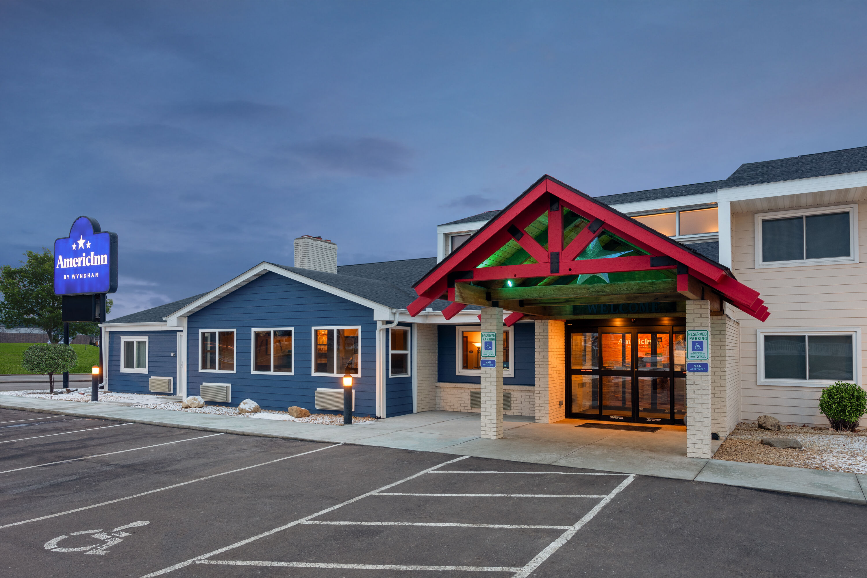 Exterior Dusk Image of AmericInn by Wyndham New Richmond hotel in New Richmond, Wisconsin