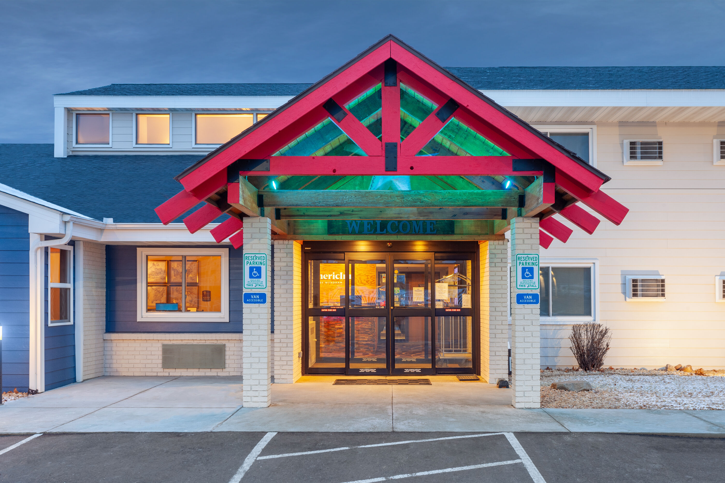 Exterior Dusk Image of AmericInn by Wyndham New Richmond hotel in New Richmond, Wisconsin