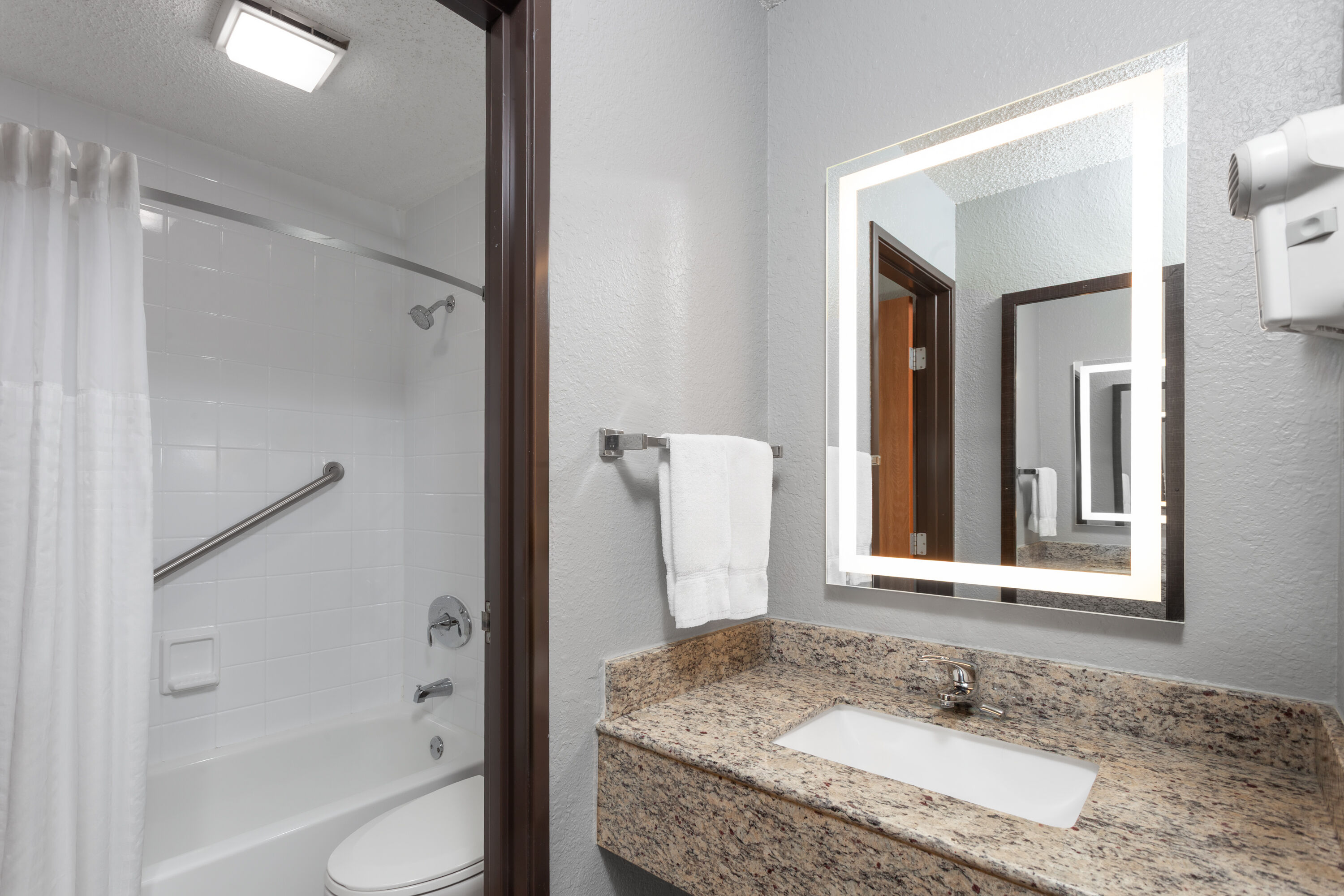 Guest room bath at the AmericInn by Wyndham Plymouth in Plymouth, Wisconsin