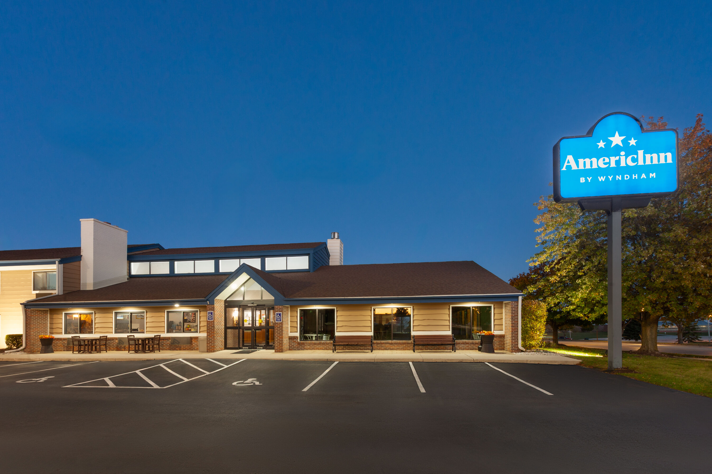 Exterior Dusk Image of AmericInn by Wyndham Plymouth hotel in Plymouth, Wisconsin