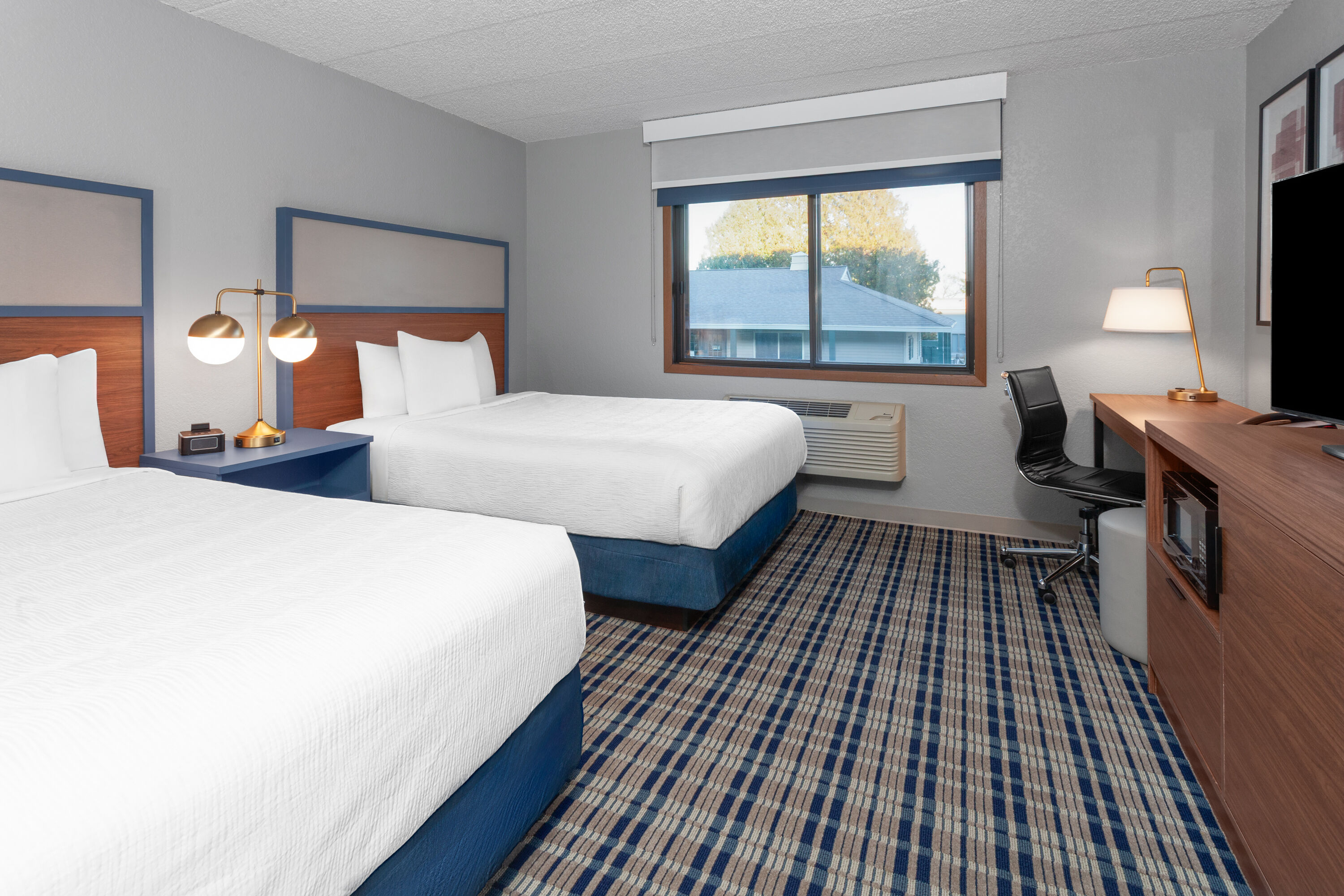 Guest room at the AmericInn by Wyndham Plymouth in Plymouth, Wisconsin