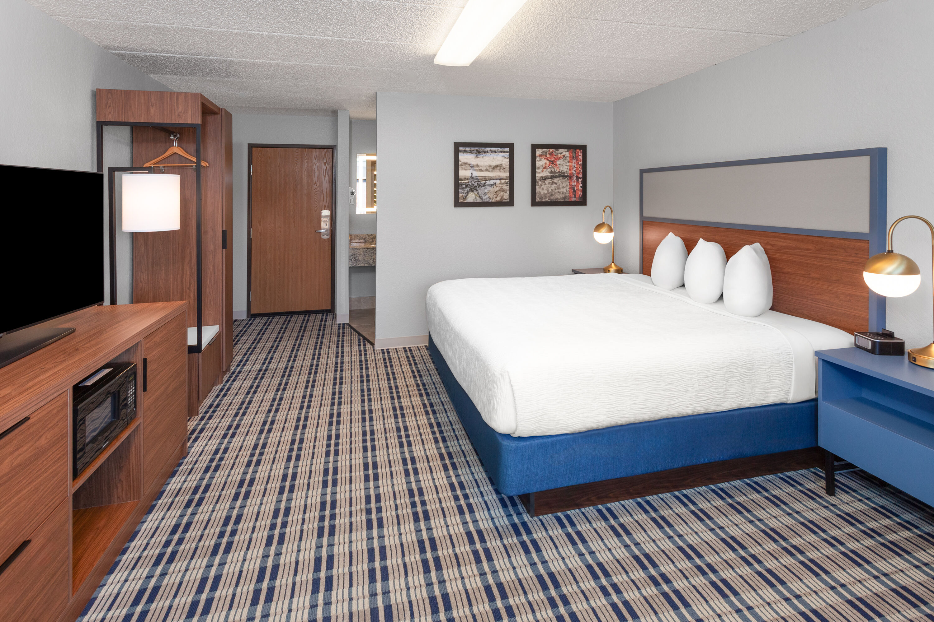 Guest room at the AmericInn by Wyndham Plymouth in Plymouth, Wisconsin