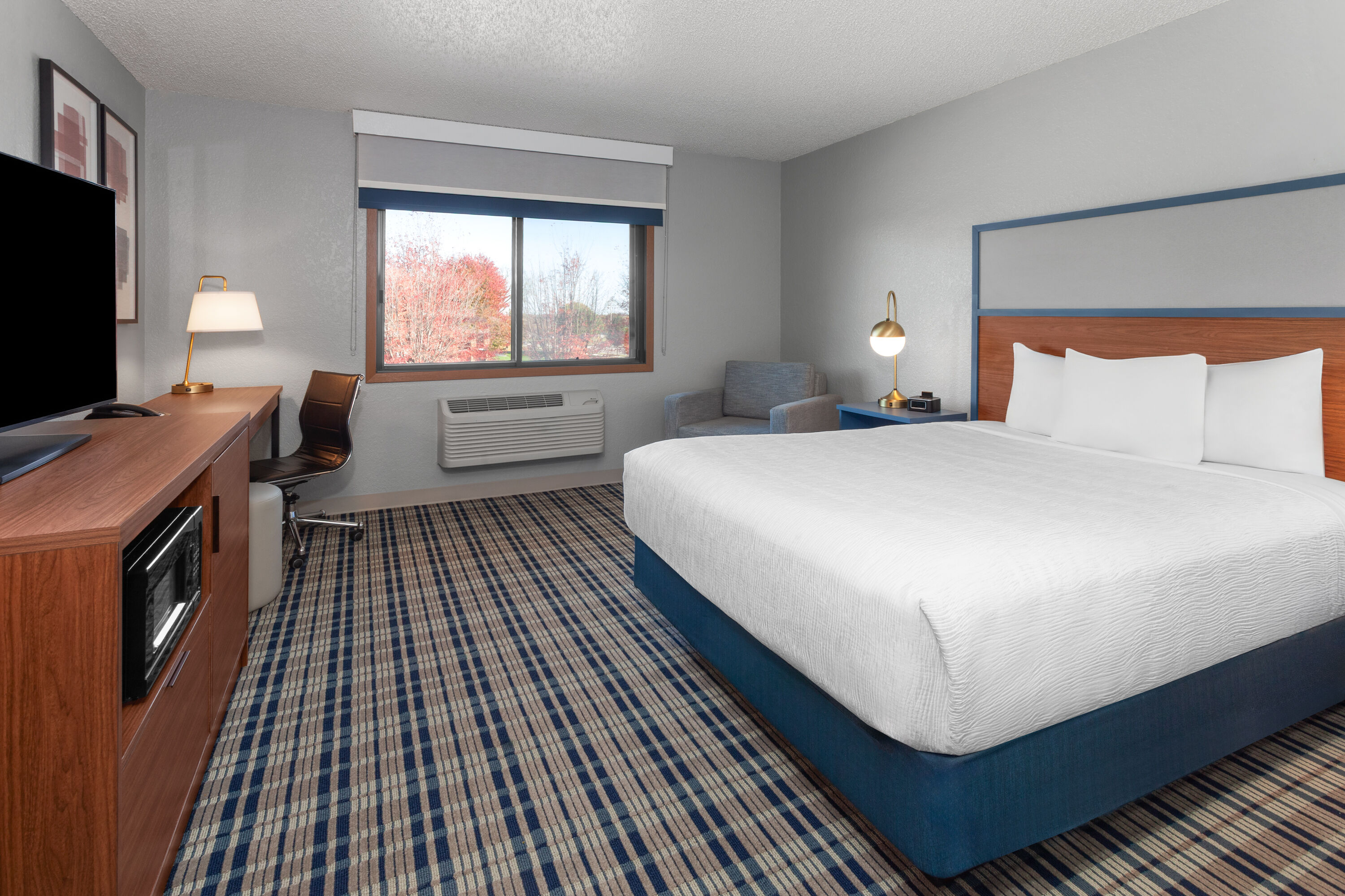Guest room at the AmericInn by Wyndham Plymouth in Plymouth, Wisconsin