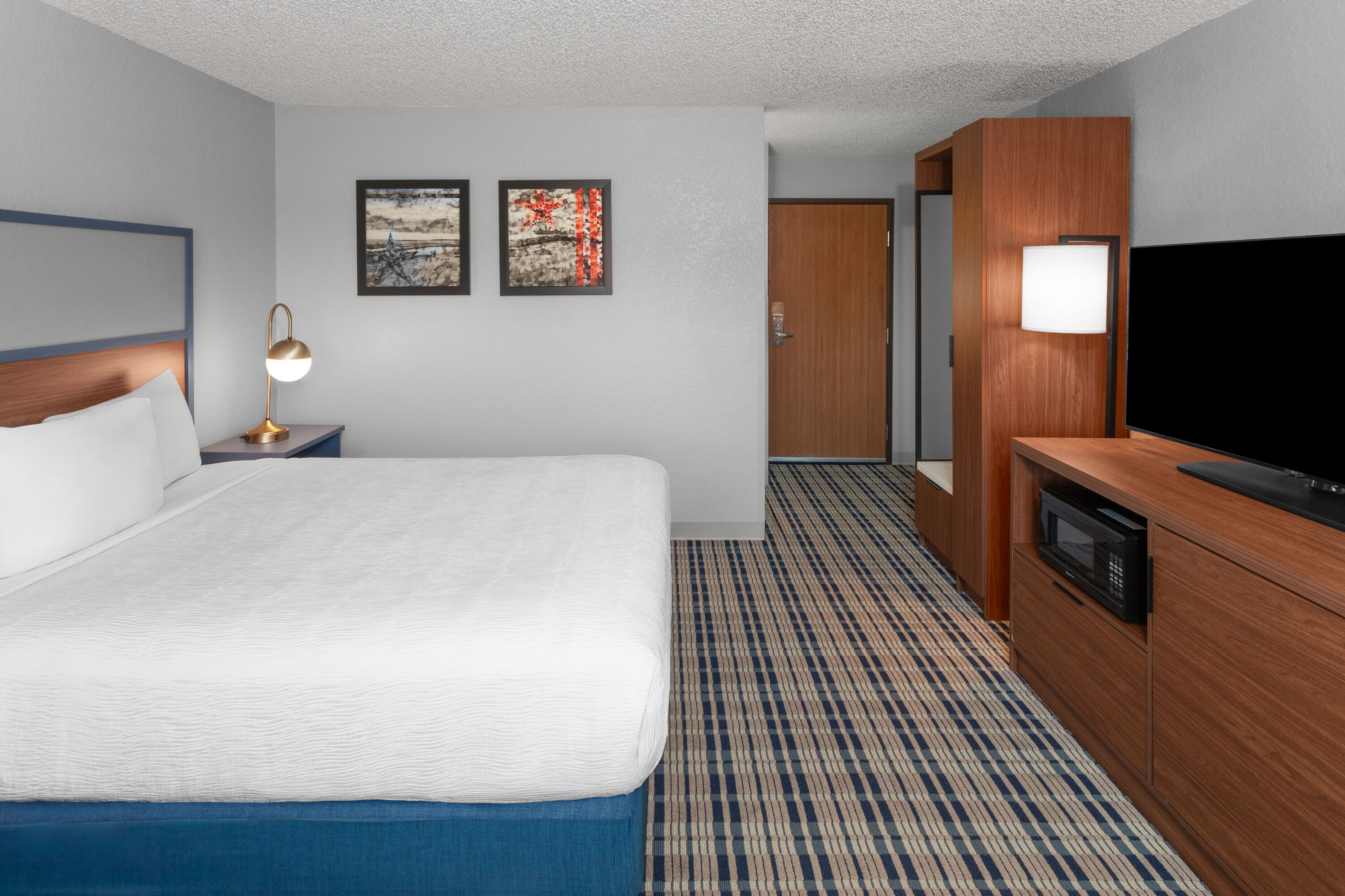Guest room at the AmericInn by Wyndham Plymouth in Plymouth, Wisconsin