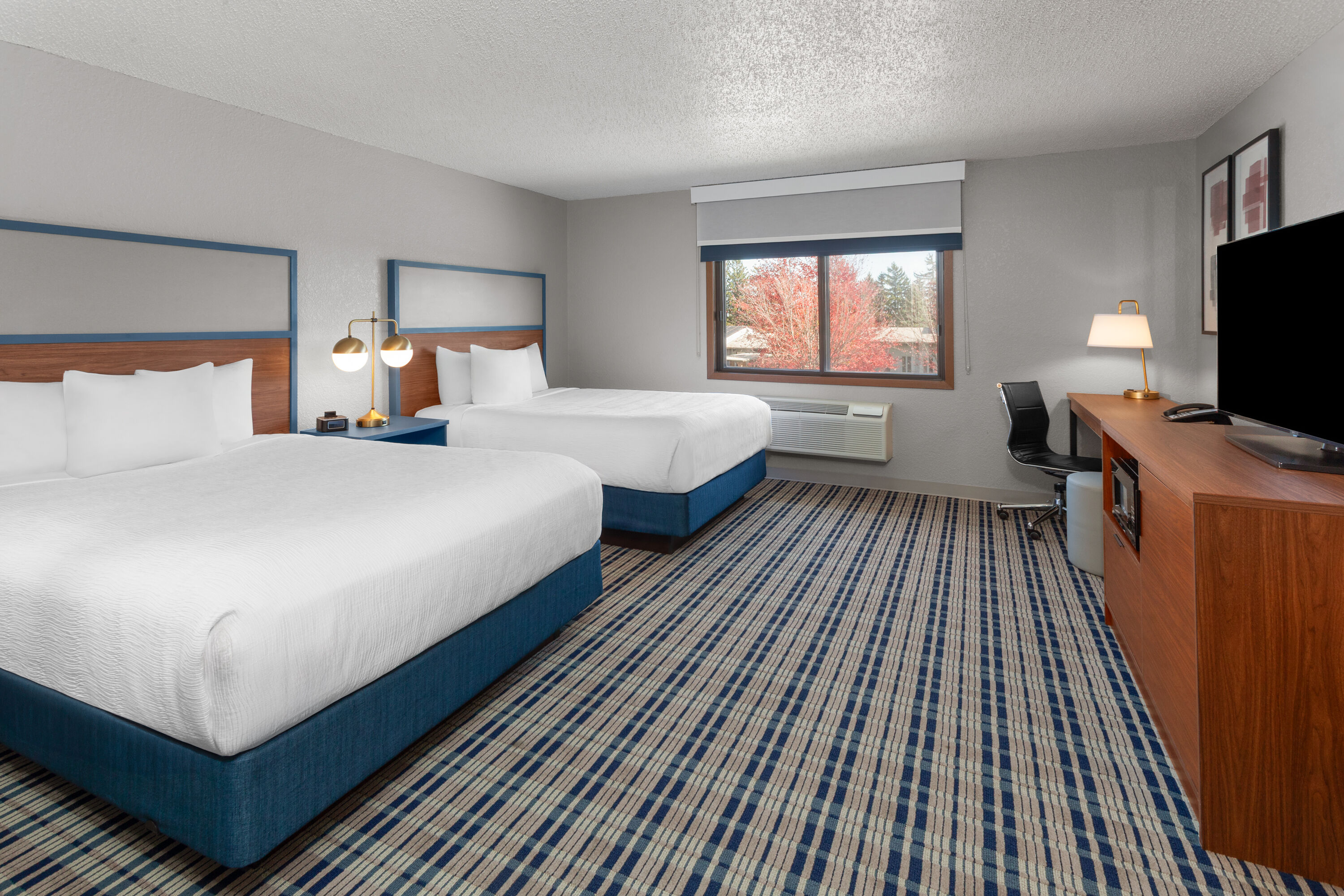 Guest room at the AmericInn by Wyndham Plymouth in Plymouth, Wisconsin