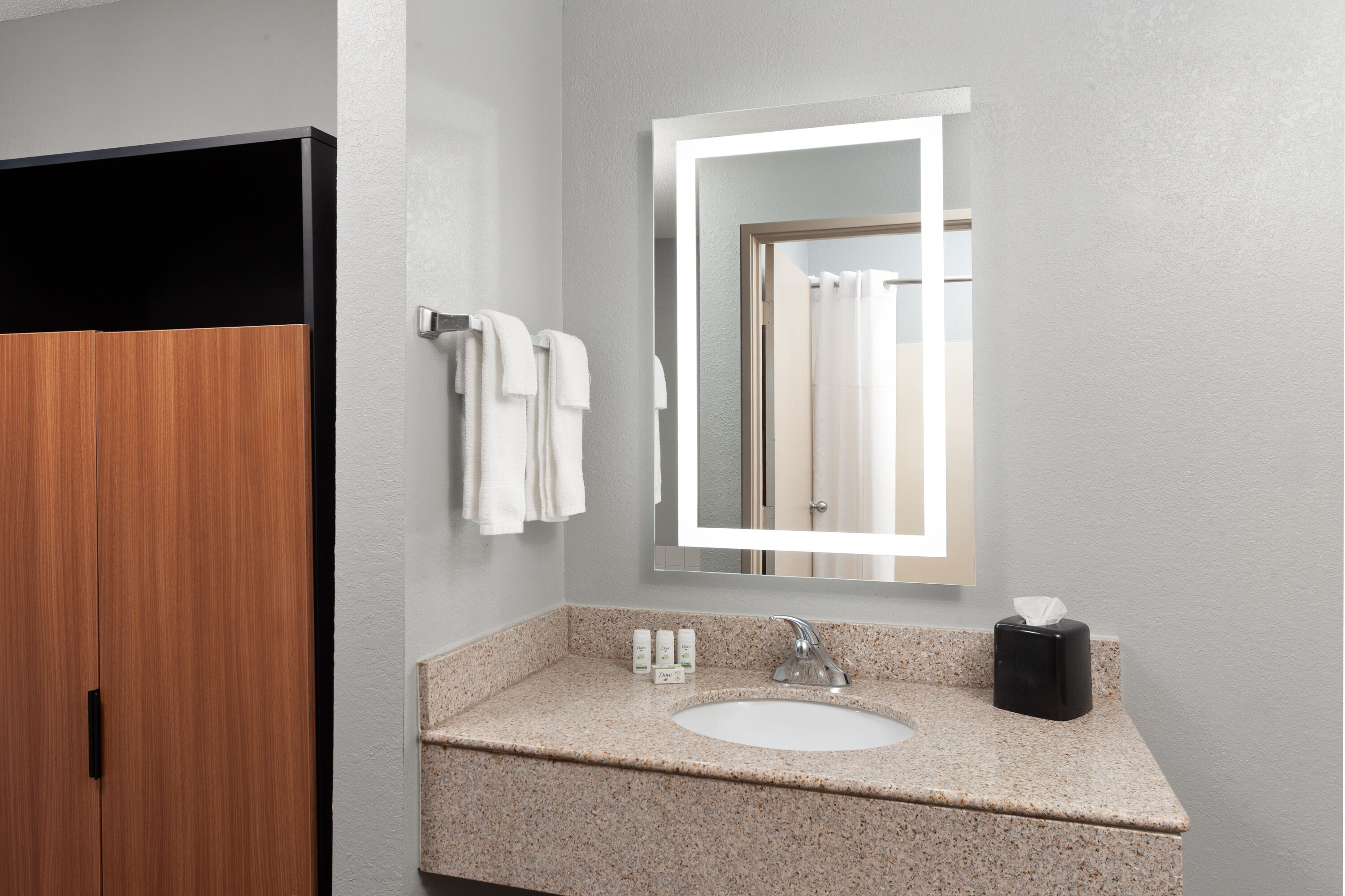 Guest room bath at the AmericInn by Wyndham Reedsburg in Reedsburg, Wisconsin