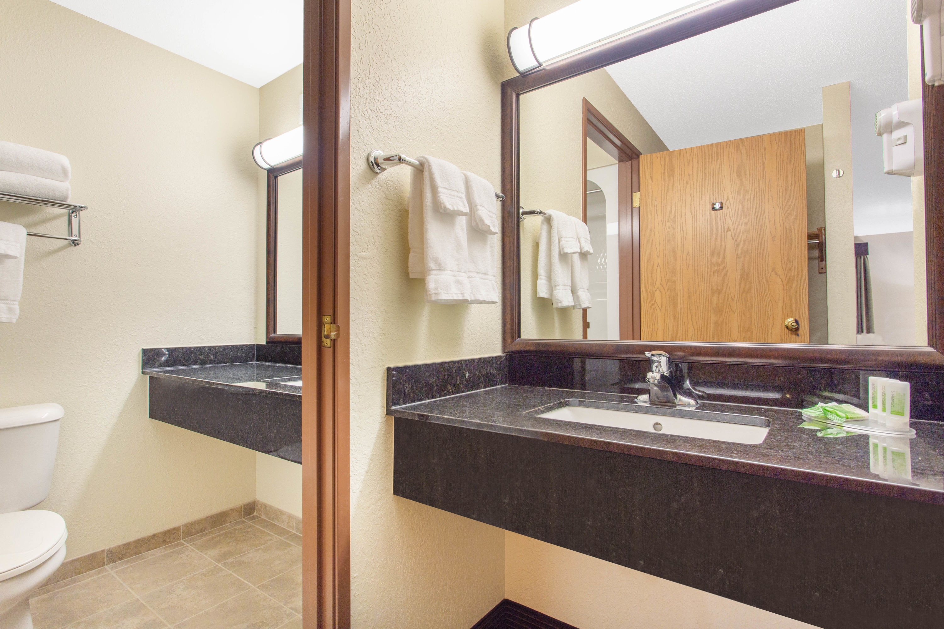 Guest room bath at the AmericInn by Wyndham Rhinelander in Rhinelander, Wisconsin