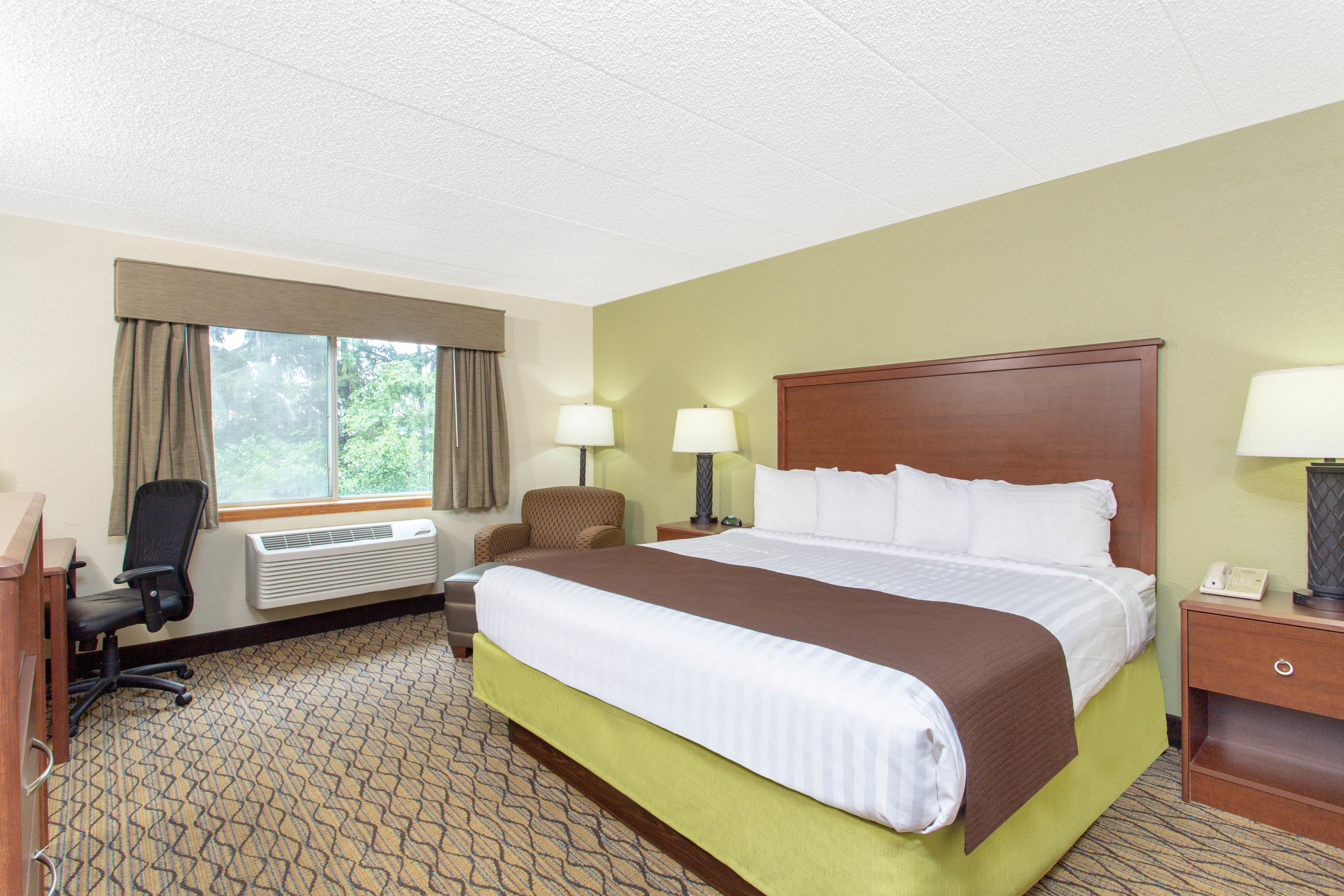 Guest room at the AmericInn by Wyndham Sheboygan in Sheboygan, Wisconsin