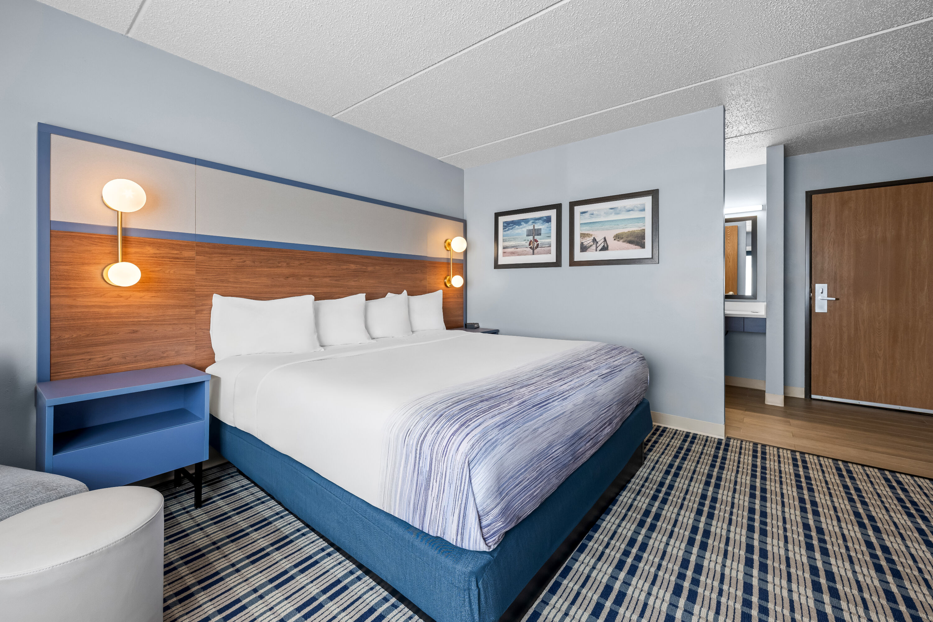 King bed guest room at the AmericInn by Wyndham Sturgeon Bay in Sturgeon Bay, Wisconsin