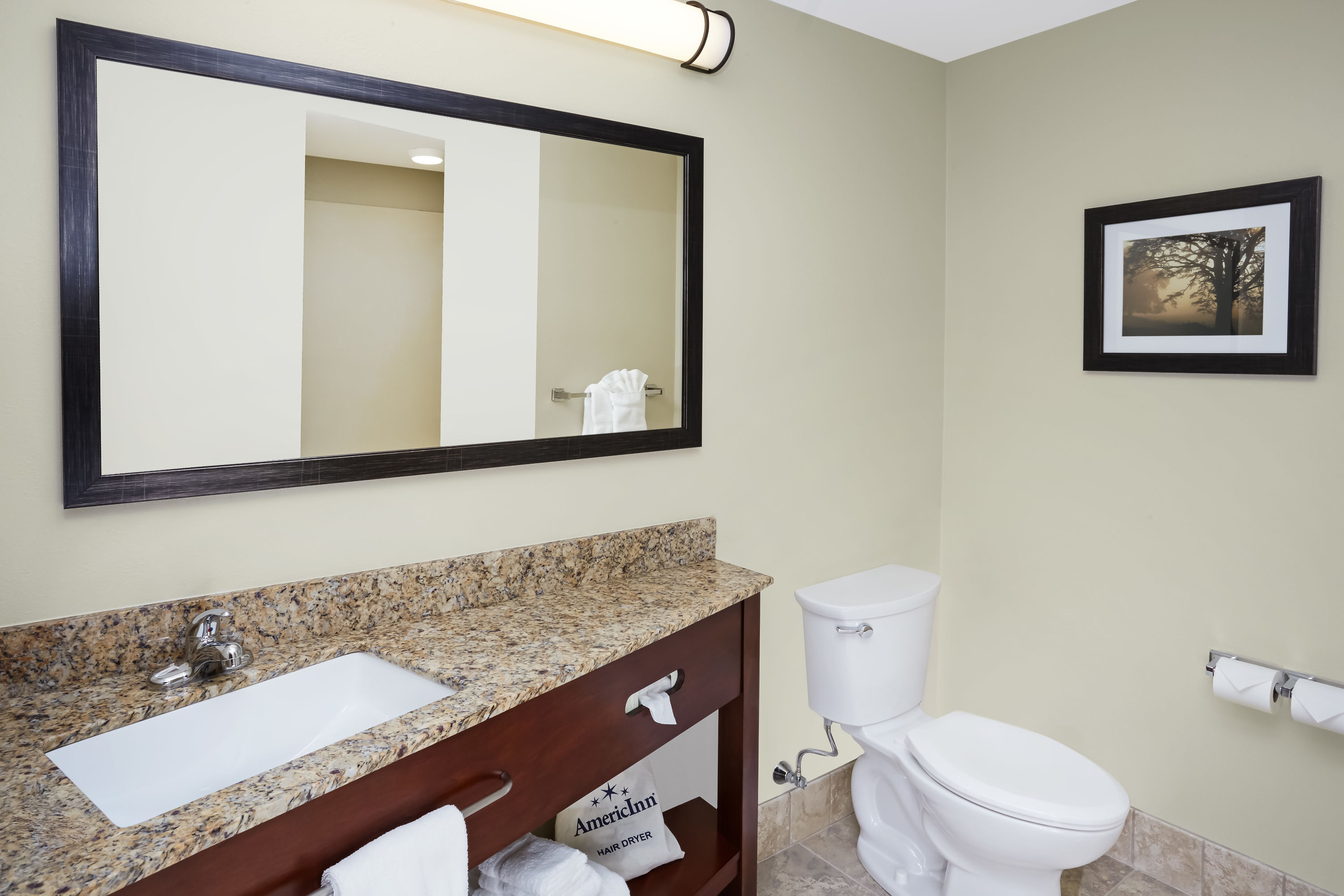 Guest room bath at the AmericInn by Wyndham Waupun in Waupun, Wisconsin