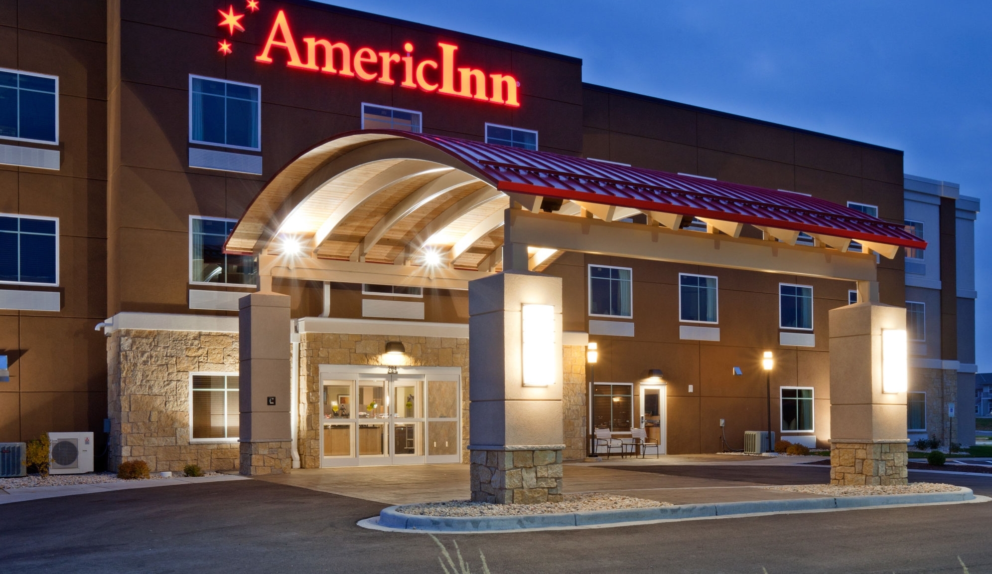 Exterior Dusk Image of AmericInn by Wyndham Waupun hotel in Waupun, Wisconsin