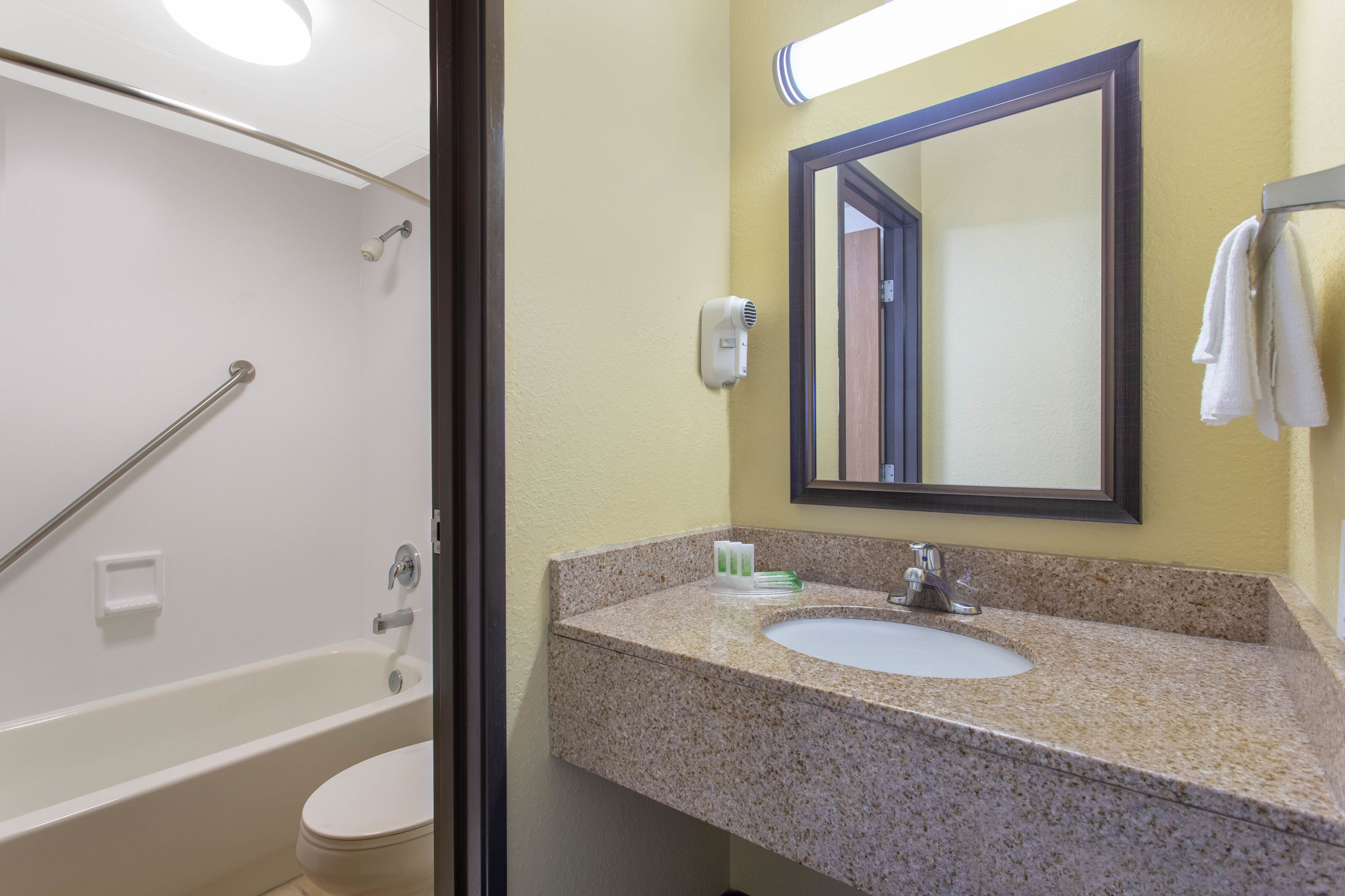 Guest room bath at the AmericInn by Wyndham West Bend in West Bend, Wisconsin