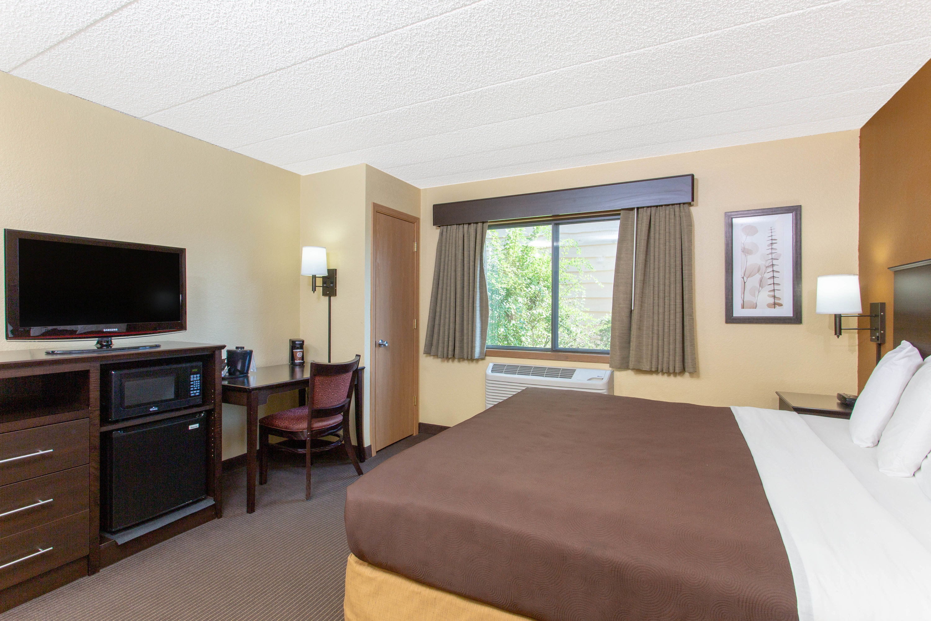 Guest room at the AmericInn by Wyndham West Bend in West Bend, Wisconsin