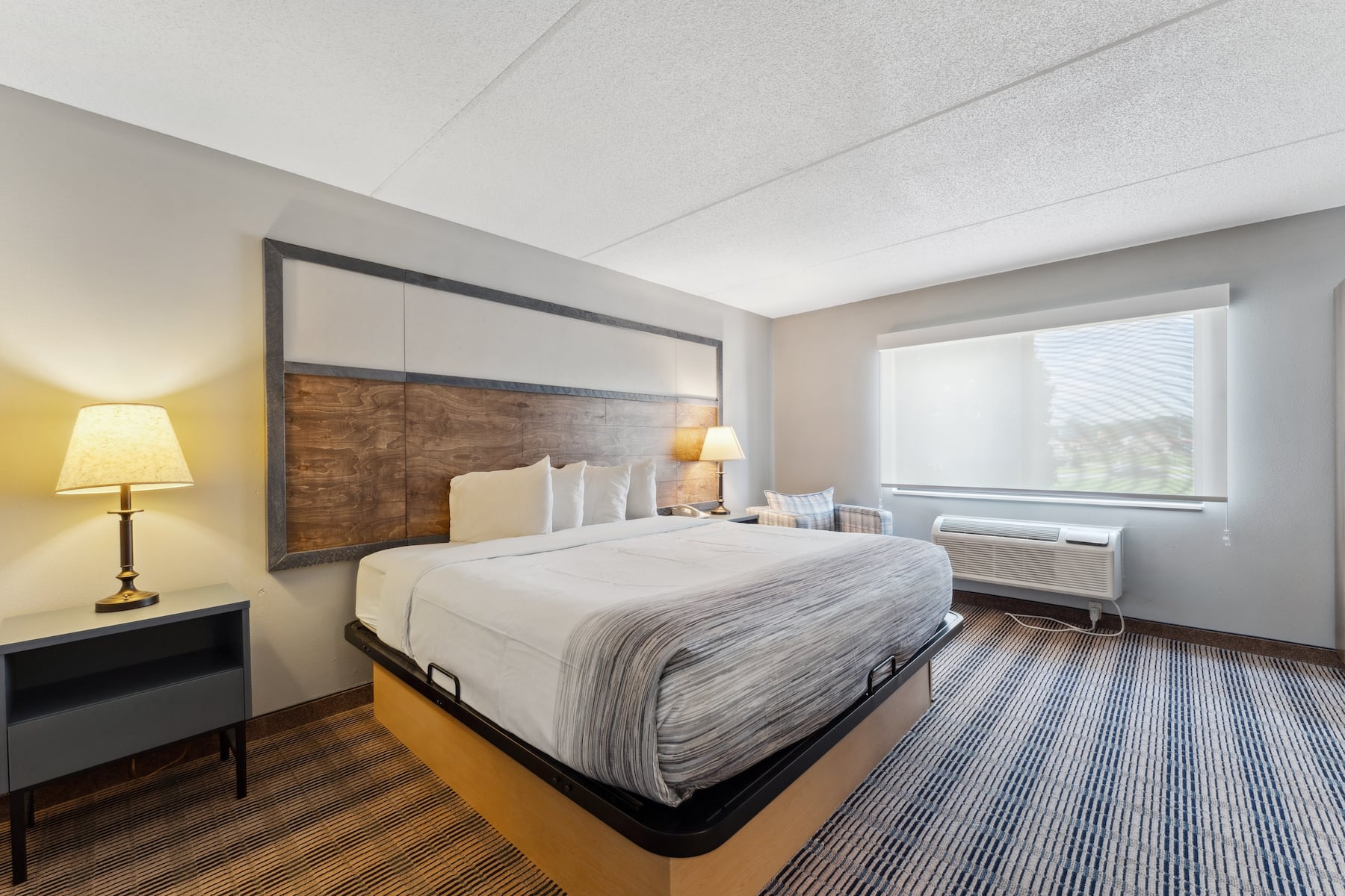 King bed guest room at the AmericInn by Wyndham Wisconsin Dells in Wisconsin Dells, Wisconsin