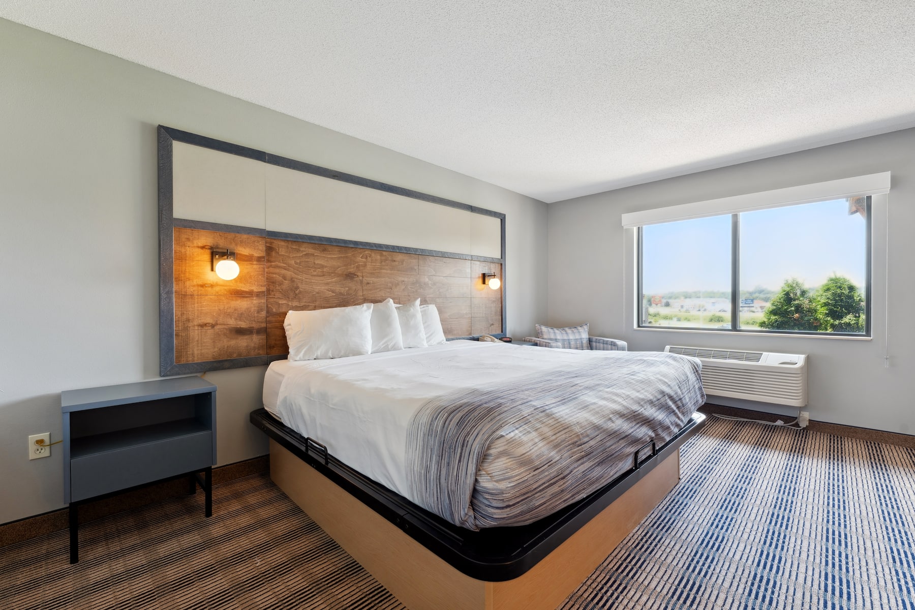 King bed guest room at the AmericInn by Wyndham Wisconsin Dells in Wisconsin Dells, Wisconsin