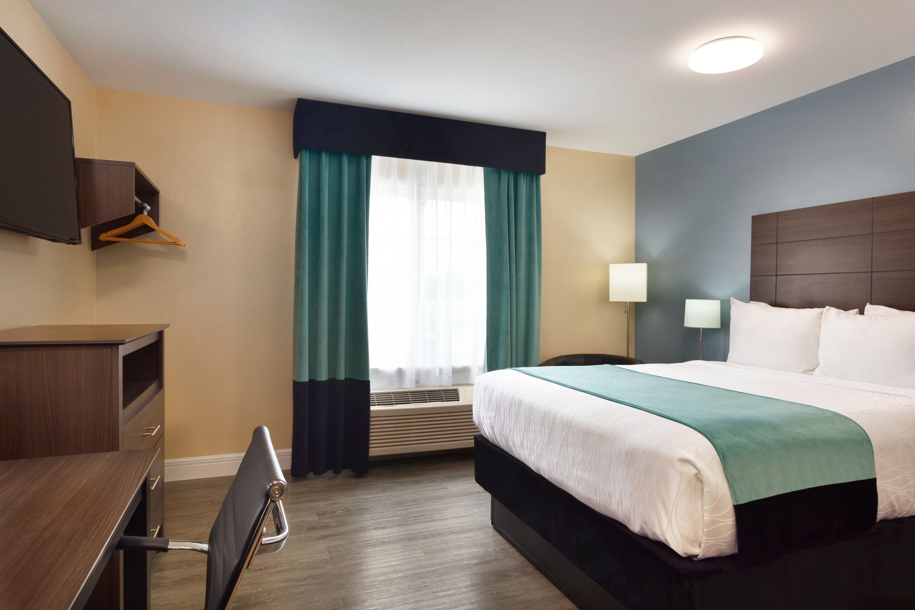 Queen bed guest room at the Hawthorn Extended Stay by Wyndham Saint Robert in Saint Robert, Missouri