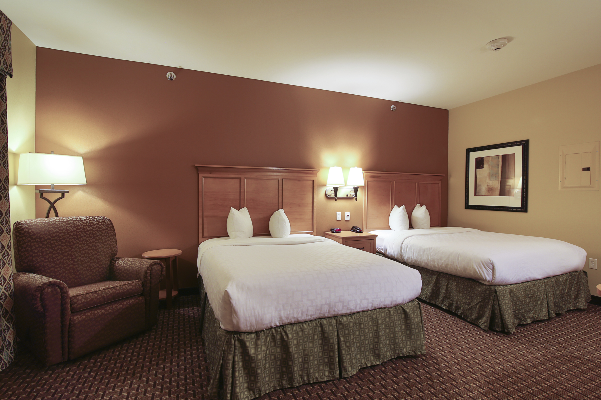 Queen bed guest room at the Hawthorn Extended Stay by Wyndham Minot in Minot, North Dakota