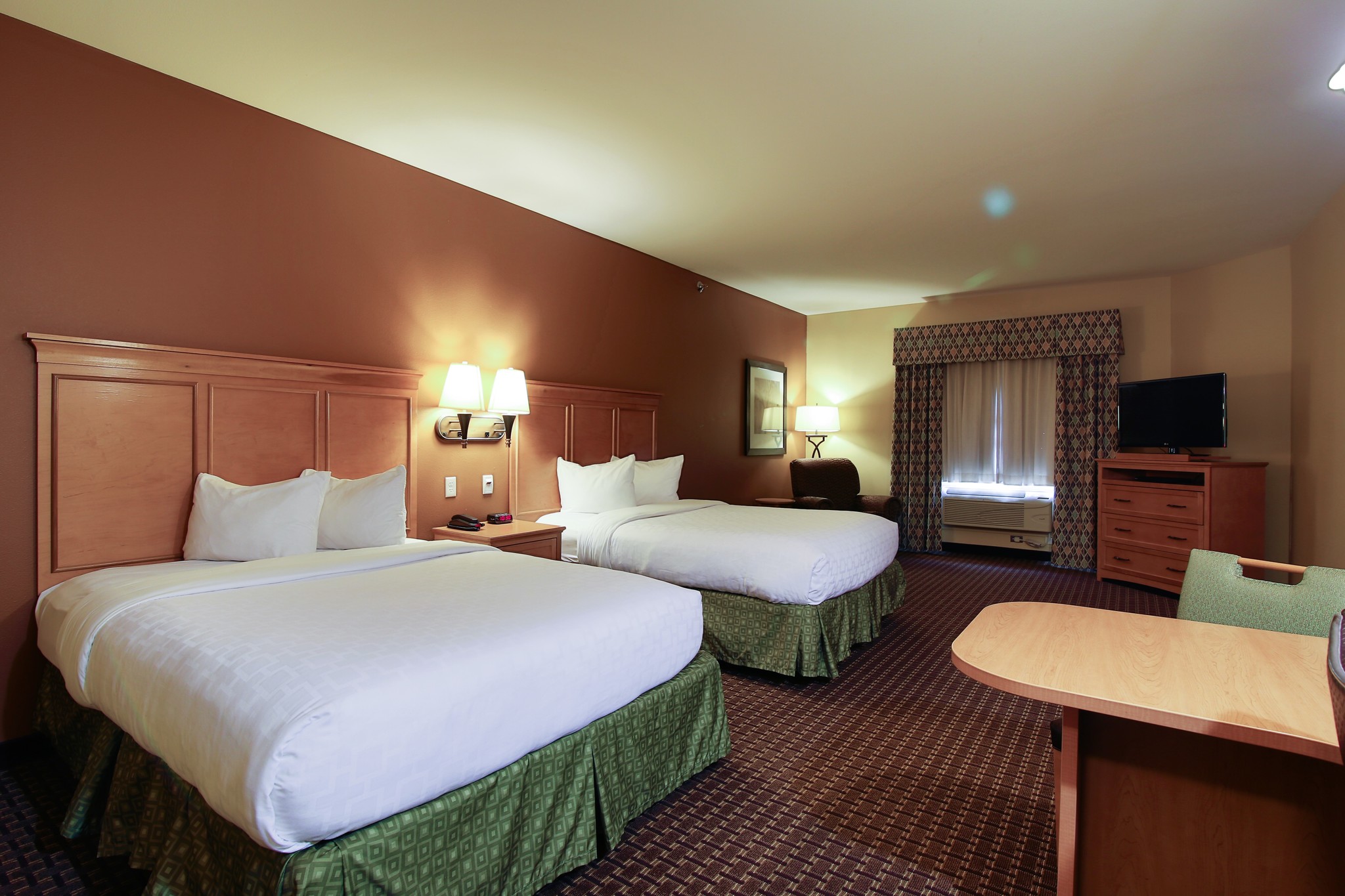 Queen bed guest room at the Hawthorn Extended Stay by Wyndham Minot in Minot, North Dakota