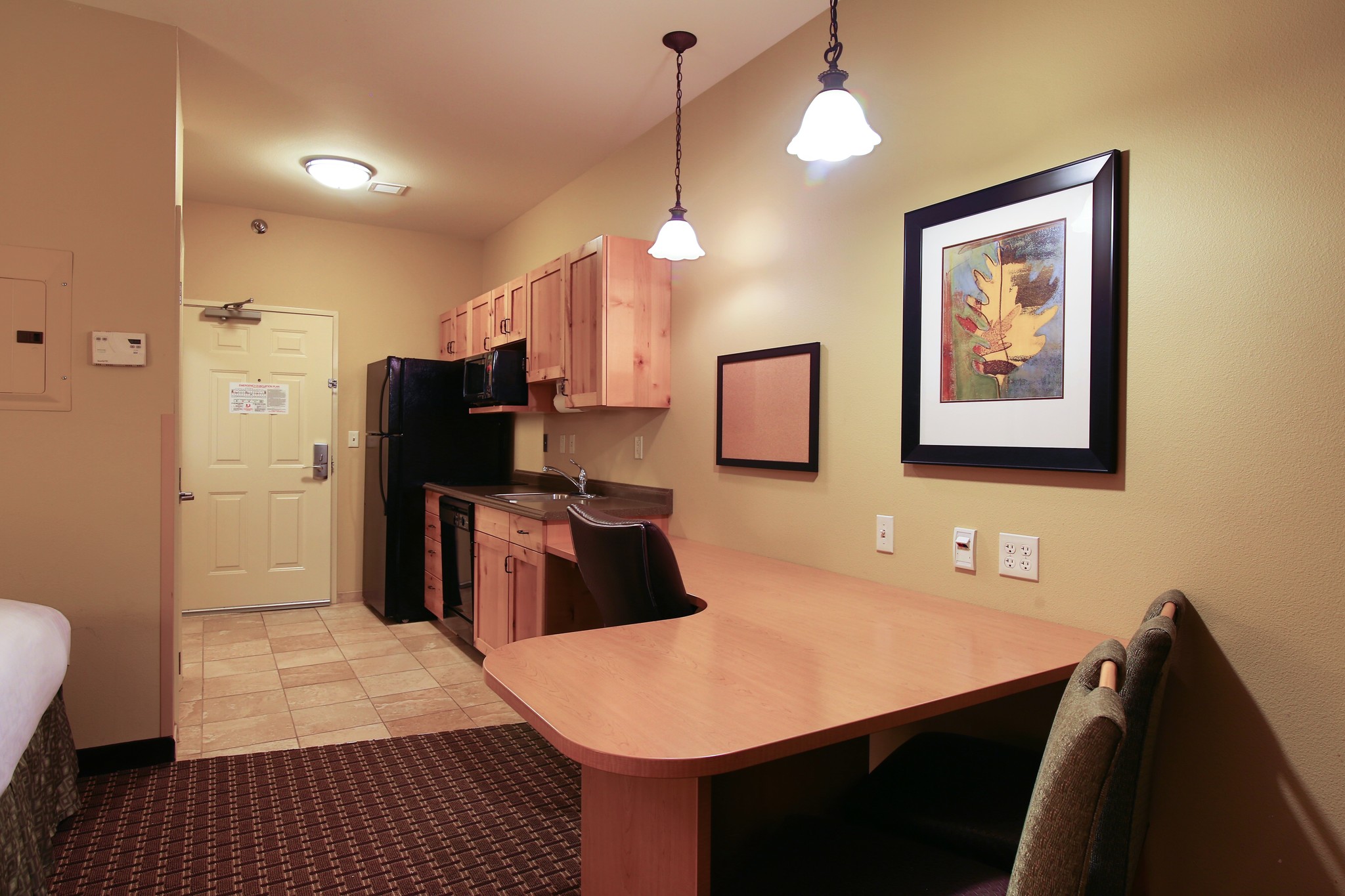 Queen bed guest room at the Hawthorn Extended Stay by Wyndham Minot in Minot, North Dakota