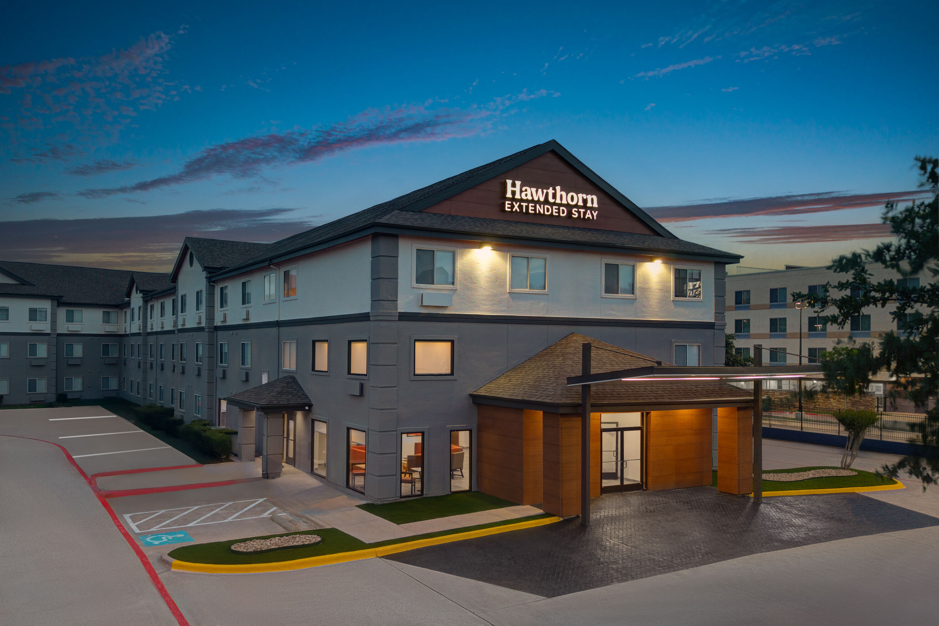 Exterior Dusk Image of Hawthorn Extended Stay by Wyndham DFW Airport North hotel in Irving, Texas