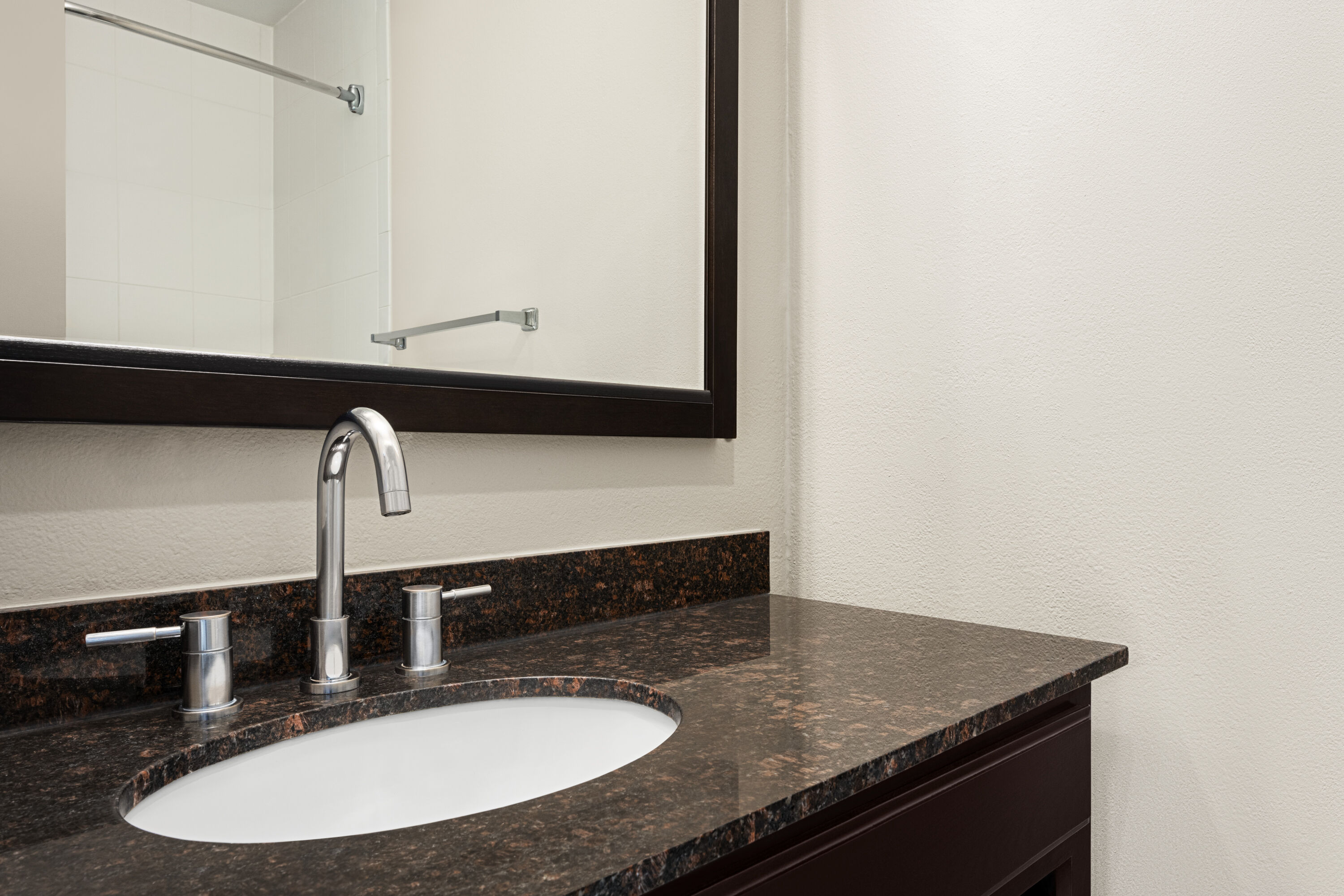 Guest room bath at the Baymont by Wyndham Monterey Park in Monterey Park, California
