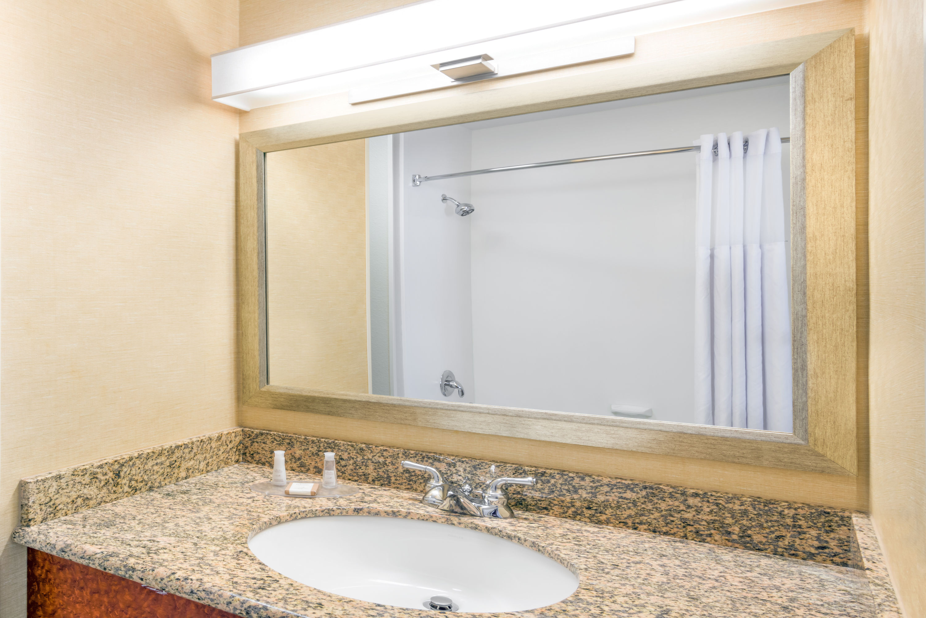 Guest room bath at the Baymont by Wyndham Denver International Airport in Denver, Colorado